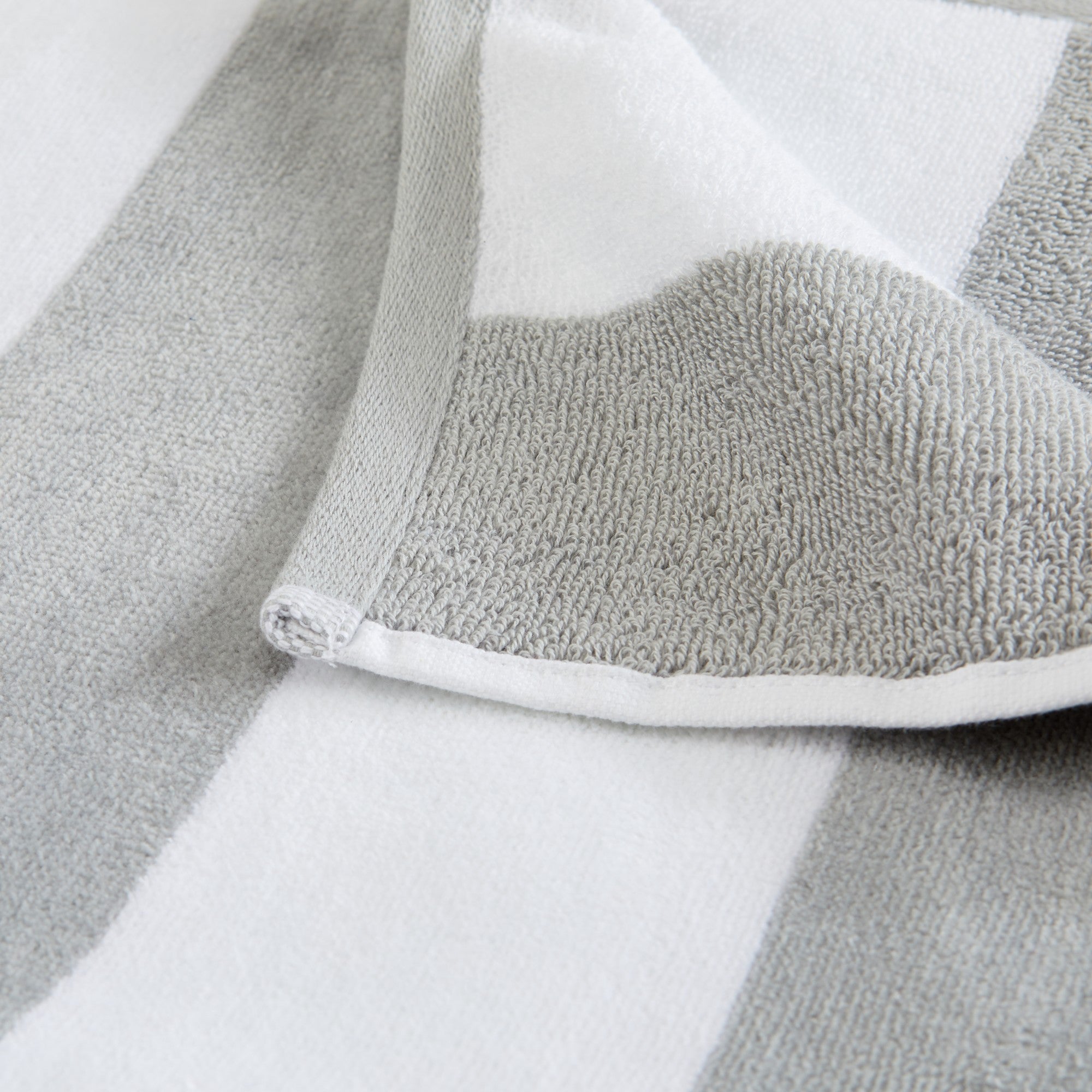 Marina Collection cotton cabana stripe beach towels in assorted colors and sizes, featuring classic striped designs and soft, absorbent 100% cotton velour construction, shown folded, stacked, and styled for poolside and beach use.