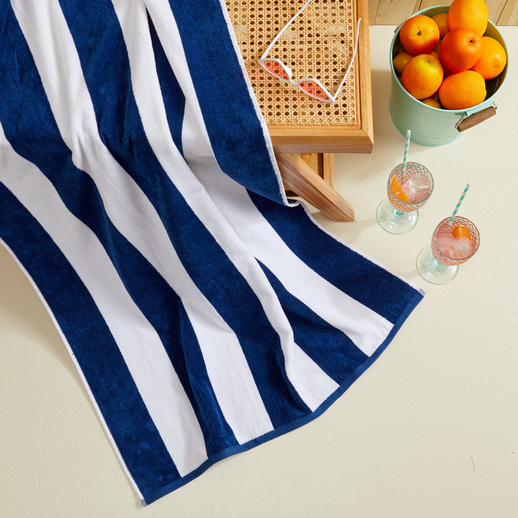 Marina Collection cotton cabana stripe beach towels in assorted colors and sizes, featuring classic striped designs and soft, absorbent 100% cotton velour construction, shown folded, stacked, and styled for poolside and beach use.