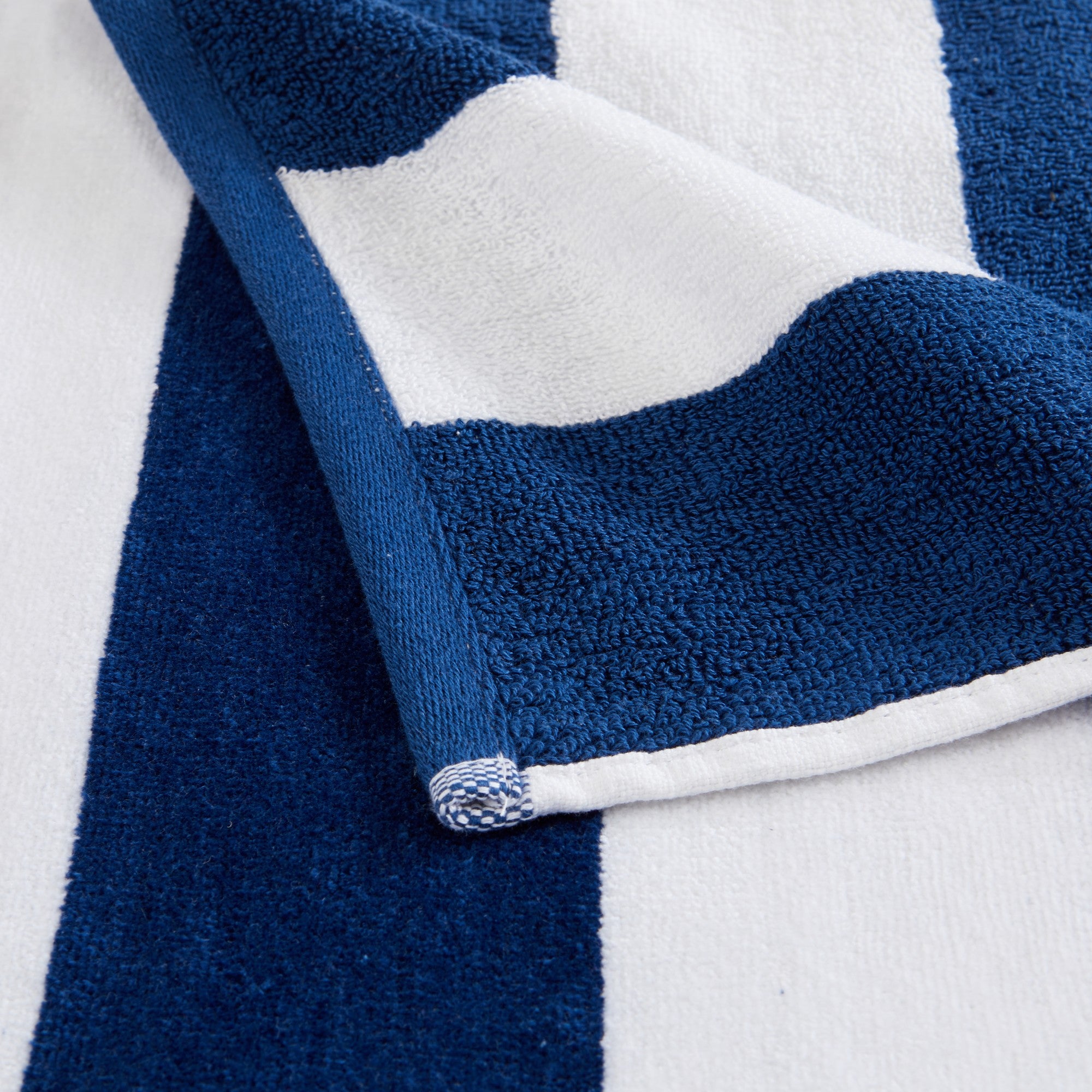 Marina Collection cotton cabana stripe beach towels in assorted colors and sizes, featuring classic striped designs and soft, absorbent 100% cotton velour construction, shown folded, stacked, and styled for poolside and beach use.