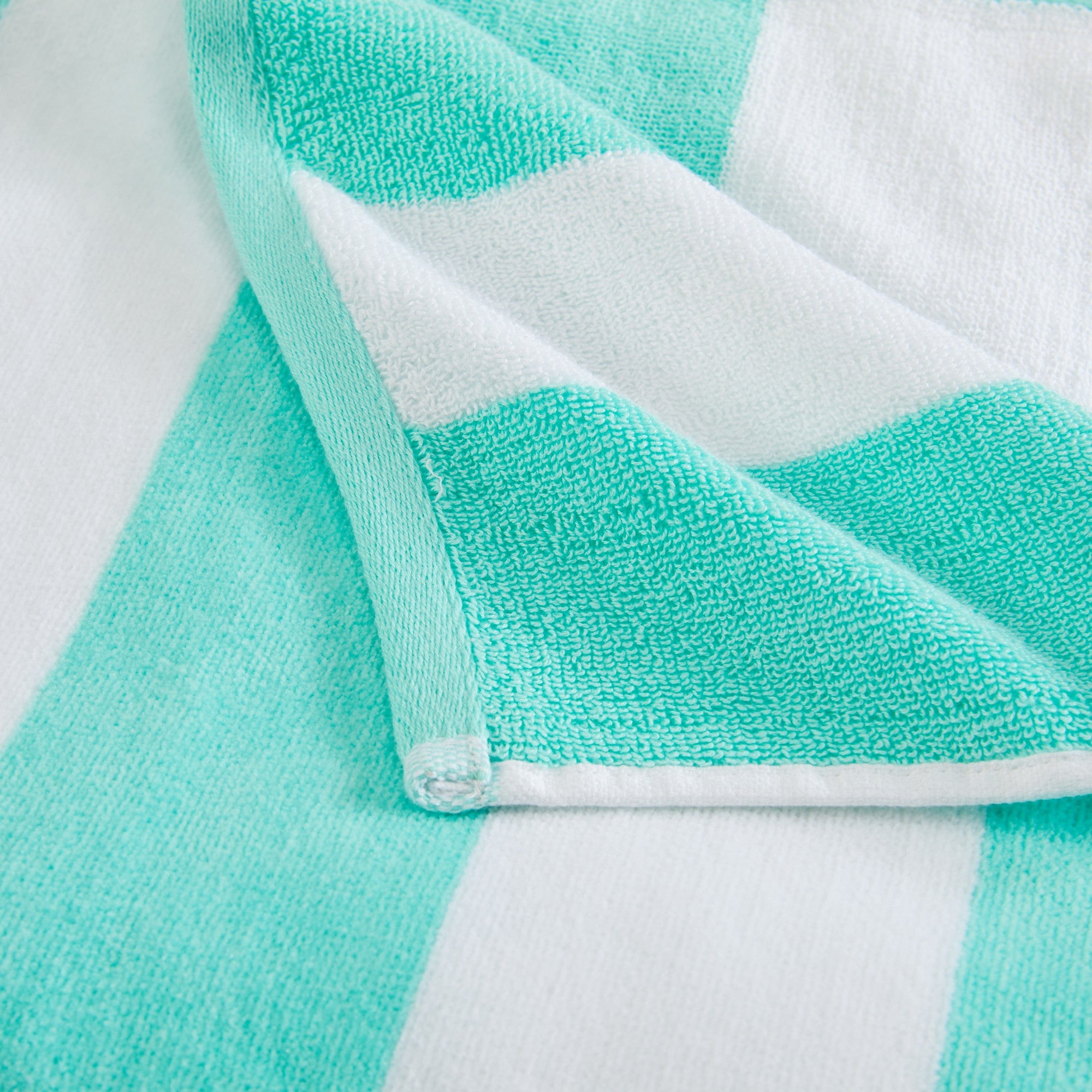 Marina Collection cotton cabana stripe beach towels in assorted colors and sizes, featuring classic striped designs and soft, absorbent 100% cotton velour construction, shown folded, stacked, and styled for poolside and beach use.