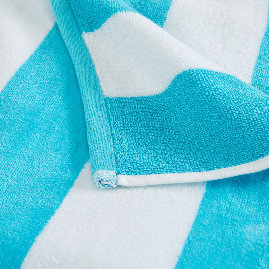 Marina Collection cotton cabana stripe beach towels in assorted colors and sizes, featuring classic striped designs and soft, absorbent 100% cotton velour construction, shown folded, stacked, and styled for poolside and beach use.