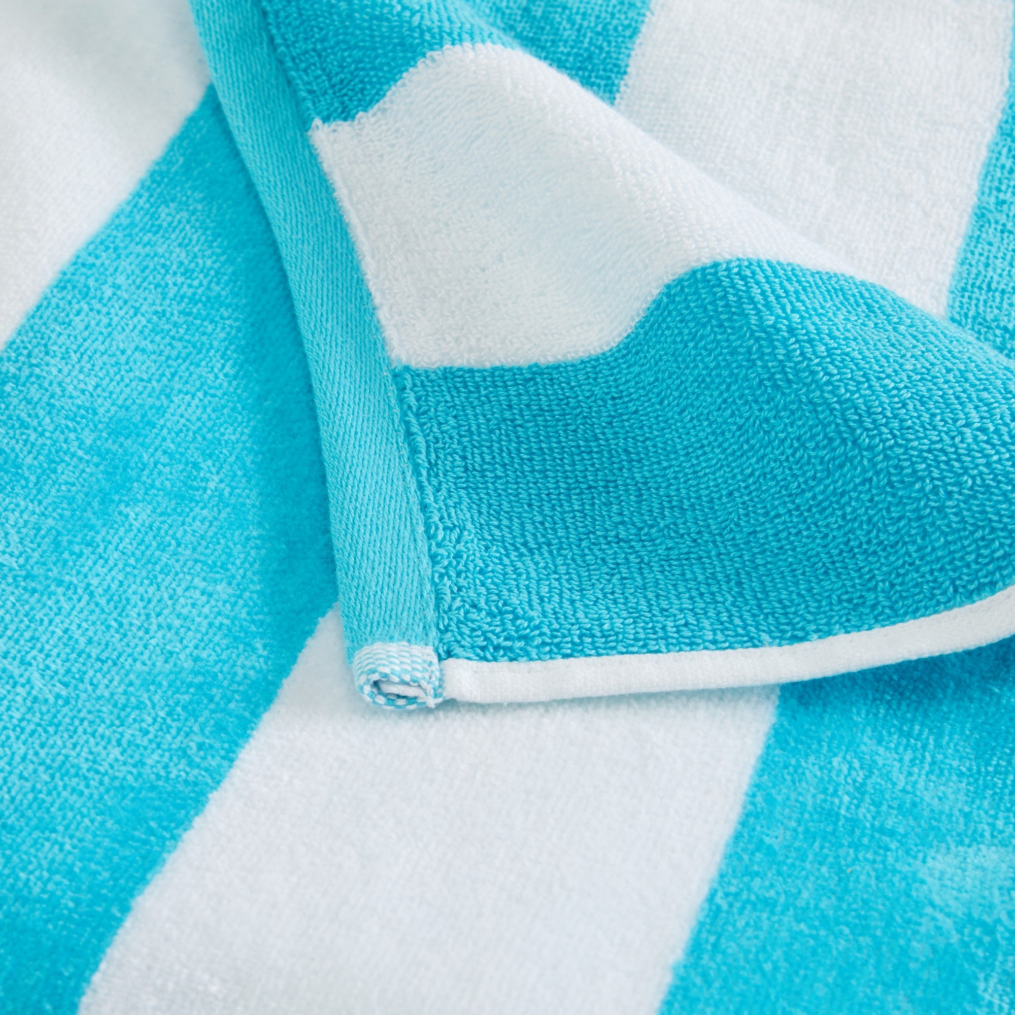Marina Collection cotton cabana stripe beach towels in assorted colors and sizes, featuring classic striped designs and soft, absorbent 100% cotton velour construction, shown folded, stacked, and styled for poolside and beach use.