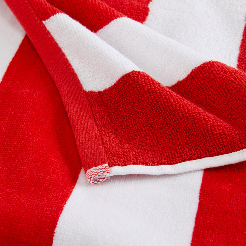 Marina Collection cotton cabana stripe beach towels in assorted colors and sizes, featuring classic striped designs and soft, absorbent 100% cotton velour construction, shown folded, stacked, and styled for poolside and beach use.