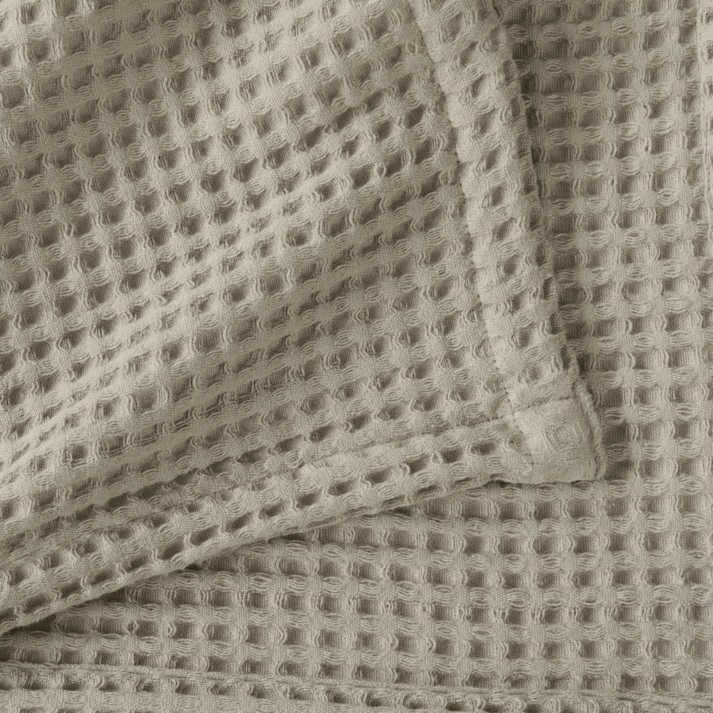 Brielle Collection Cotton Waffle Blanket by Market & Place featuring soft, breathable 100% cotton construction with a classic waffle weave texture. Available in multiple colors and shown folded, layered on beds, and in detailed fabric close-ups, highlighting its lightweight comfort and versatile year-round style.