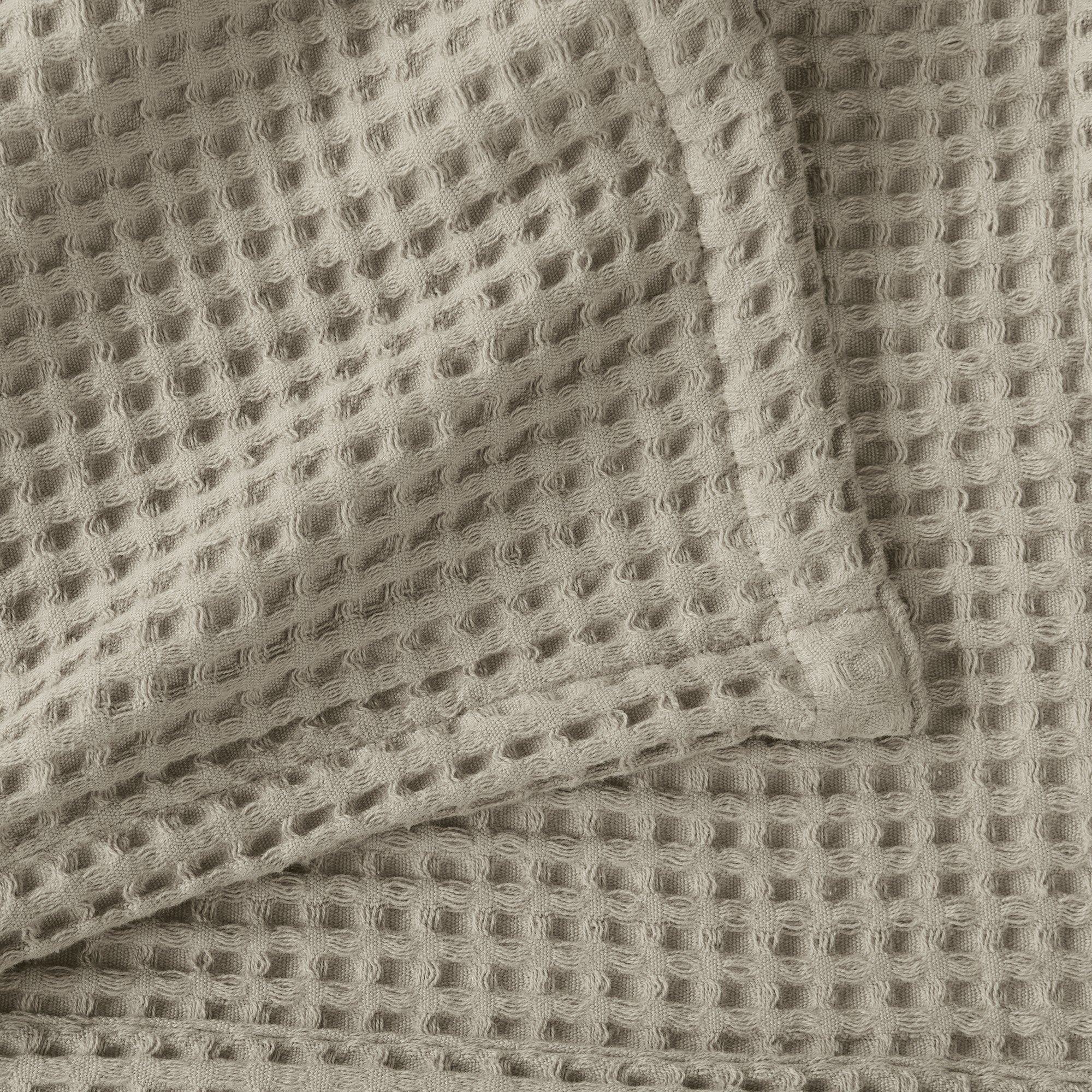Brielle Collection Cotton Waffle Blanket by Market & Place featuring soft, breathable 100% cotton construction with a classic waffle weave texture. Available in multiple colors and shown folded, layered on beds, and in detailed fabric close-ups, highlighting its lightweight comfort and versatile year-round style.
