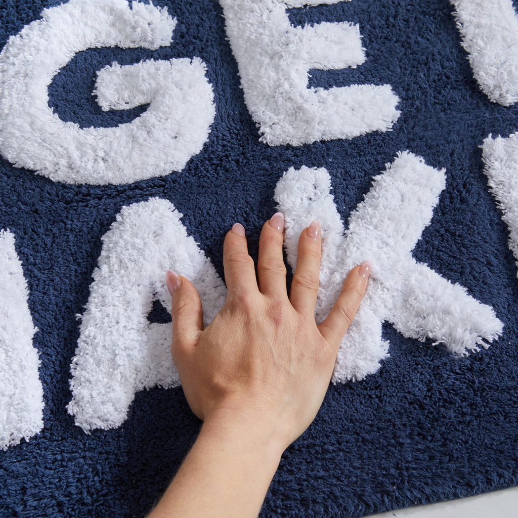 Plush tufted cotton bath rug featuring a fun decorative design with raised detailing. Soft, highly absorbent, and quick-drying, this 20 x 30 inch rug adds comfort and personality to any bathroom. Machine washable for easy care.