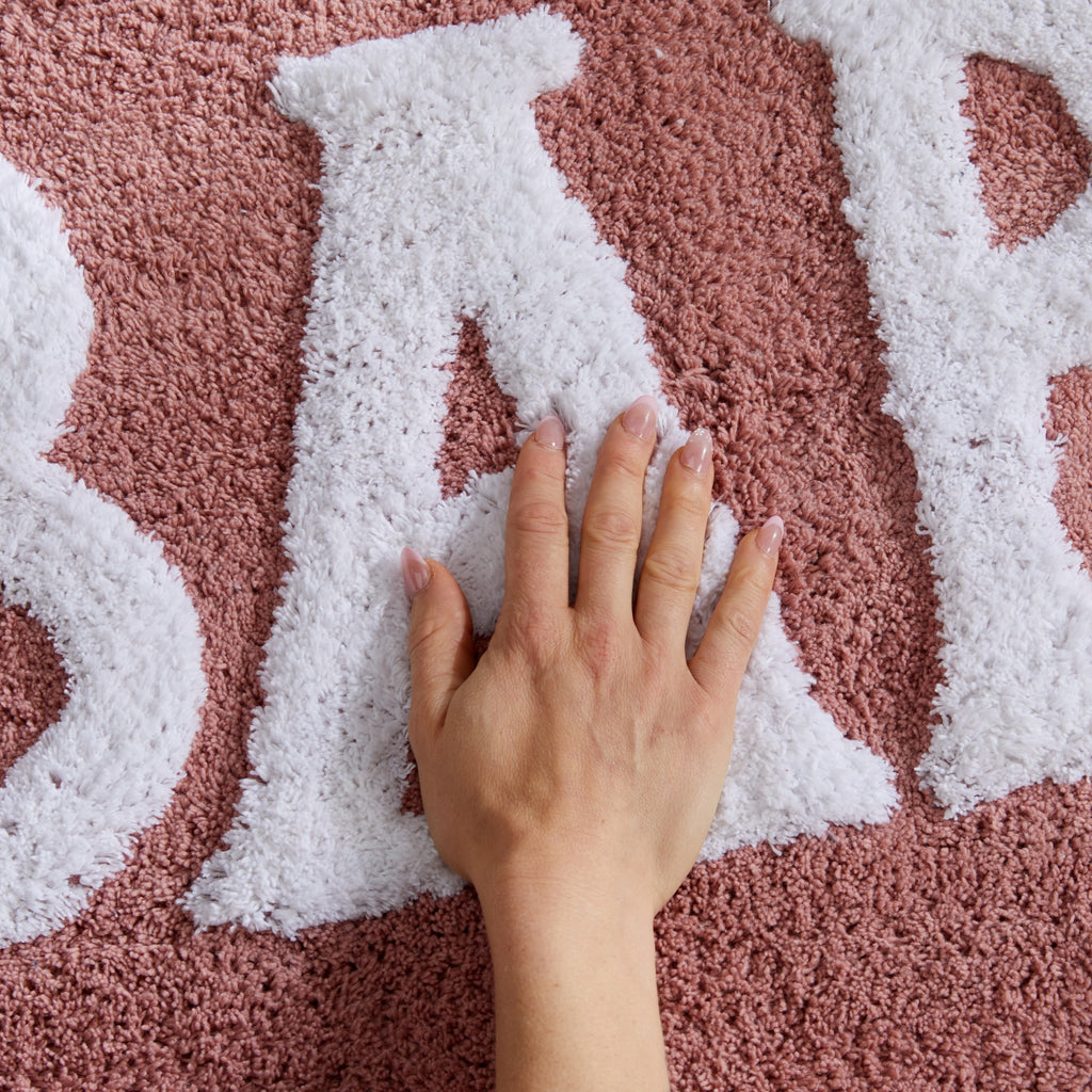 Plush tufted cotton bath rug featuring a fun decorative design with raised detailing. Soft, highly absorbent, and quick-drying, this 20 x 30 inch rug adds comfort and personality to any bathroom. Machine washable for easy care.