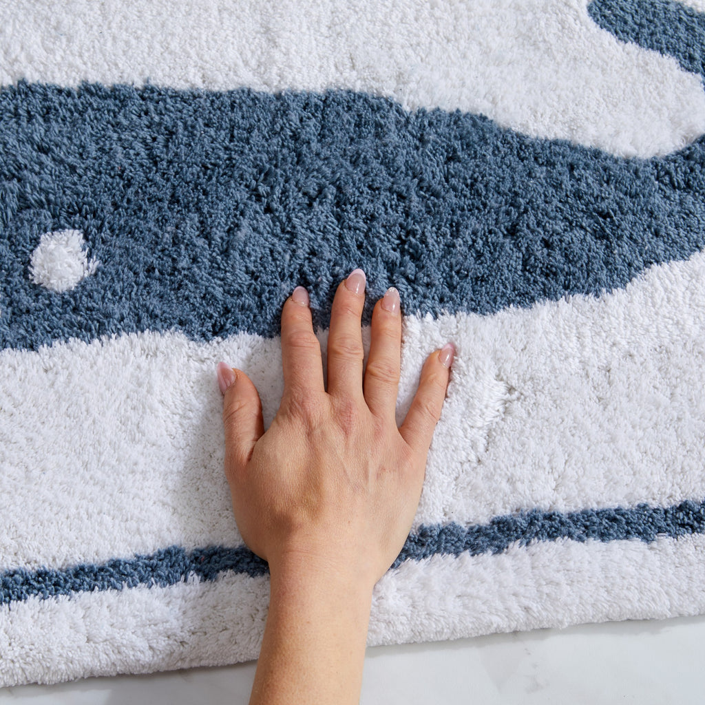 Plush tufted cotton bath rug featuring a fun decorative design with raised detailing. Soft, highly absorbent, and quick-drying, this 20 x 30 inch rug adds comfort and personality to any bathroom. Machine washable for easy care.