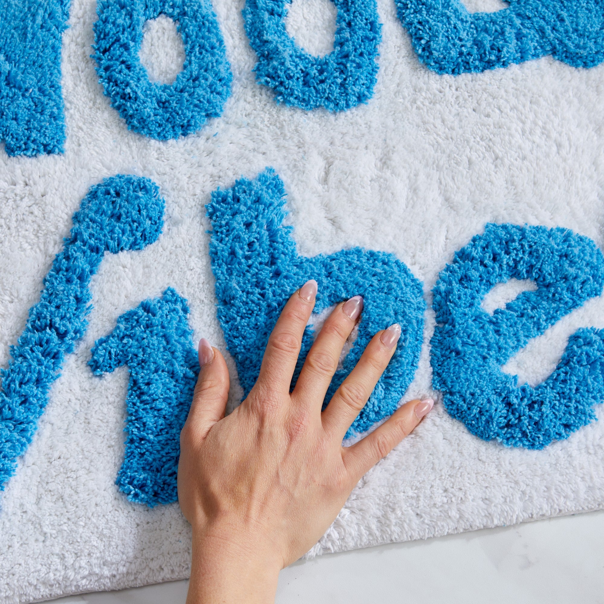 Plush tufted cotton bath rug featuring a fun decorative design with raised detailing. Soft, highly absorbent, and quick-drying, this 20 x 30 inch rug adds comfort and personality to any bathroom. Machine washable for easy care.