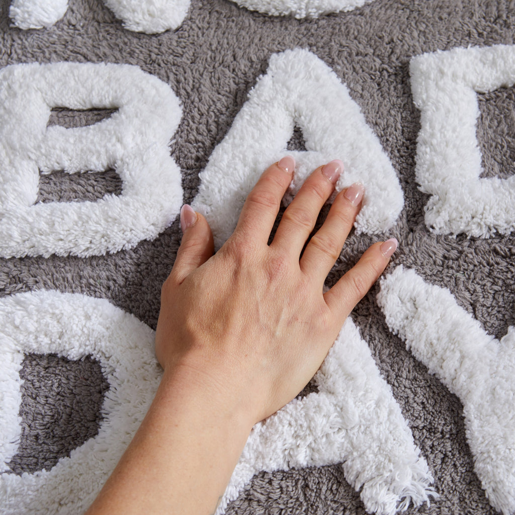 Plush tufted cotton bath rug featuring a fun decorative design with raised detailing. Soft, highly absorbent, and quick-drying, this 20 x 30 inch rug adds comfort and personality to any bathroom. Machine washable for easy care.