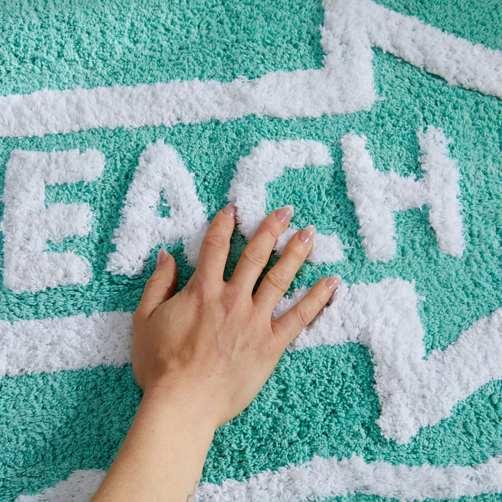 Plush tufted cotton bath rug featuring a fun decorative design with raised detailing. Soft, highly absorbent, and quick-drying, this 20 x 30 inch rug adds comfort and personality to any bathroom. Machine washable for easy care.