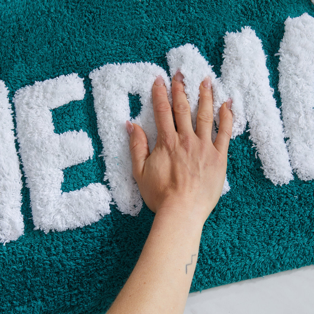 Plush tufted cotton bath rug featuring a fun decorative design with raised detailing. Soft, highly absorbent, and quick-drying, this 20 x 30 inch rug adds comfort and personality to any bathroom. Machine washable for easy care.