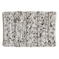 Space-dyed microfiber bath rug featuring a textured pebble-like surface in soft ivory and gray tones. The plush, absorbent design adds comfort underfoot while bringing subtle texture and modern style to any bathroom space.