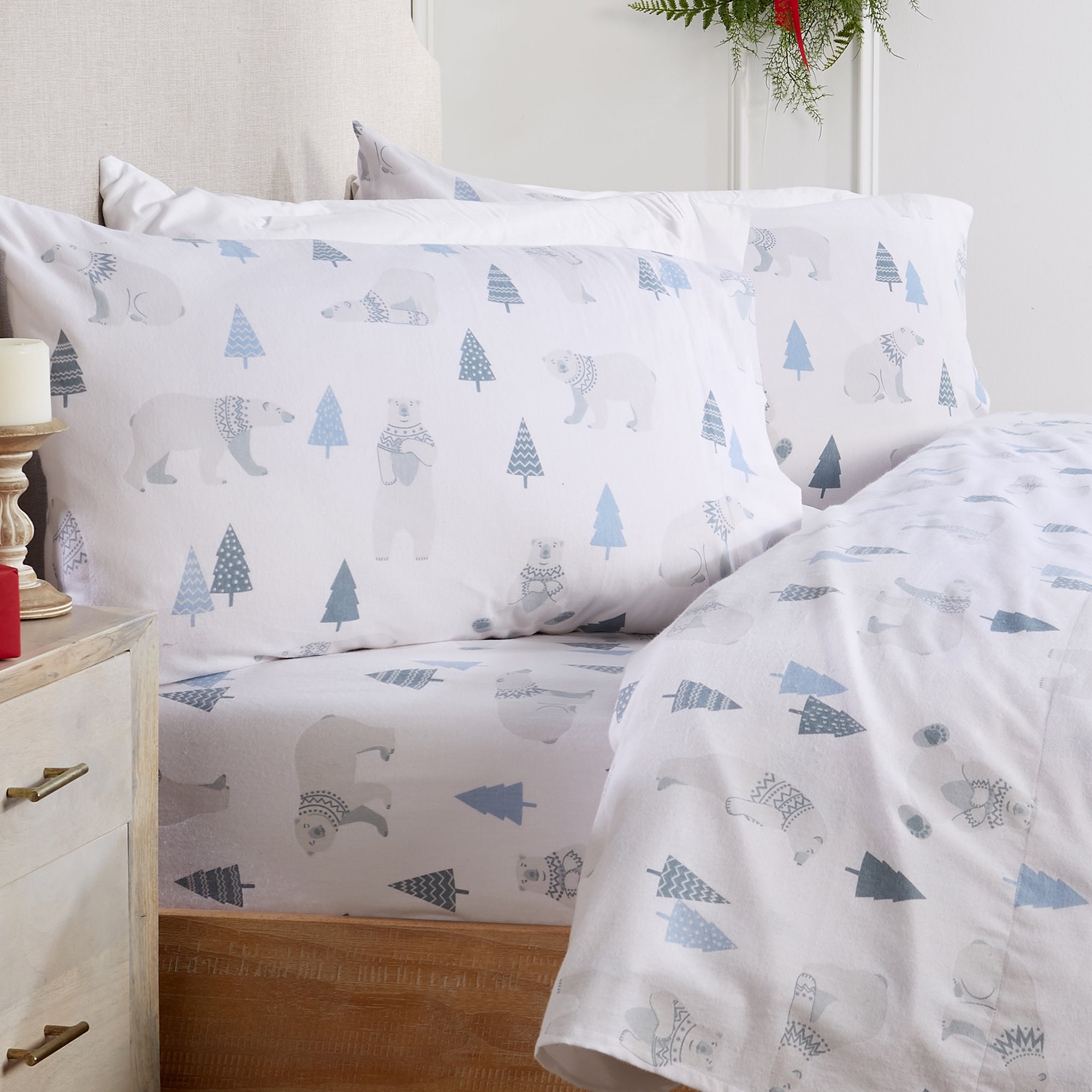 Printed 100% Turkish cotton flannel sheet set featuring assorted winter-inspired patterns, including woodland animals, snowflakes, trees, plaids, and seasonal motifs. Soft, cozy bedding shown in styled bedroom settings with close-up fabric details and folded sheet stacks in multiple designs.