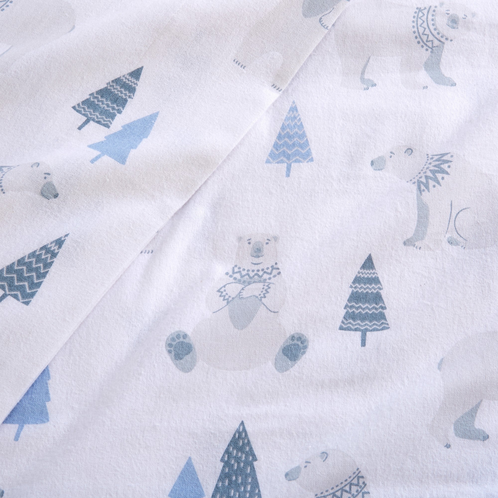 Printed 100% Turkish cotton flannel sheet set featuring assorted winter-inspired patterns, including woodland animals, snowflakes, trees, plaids, and seasonal motifs. Soft, cozy bedding shown in styled bedroom settings with close-up fabric details and folded sheet stacks in multiple designs.