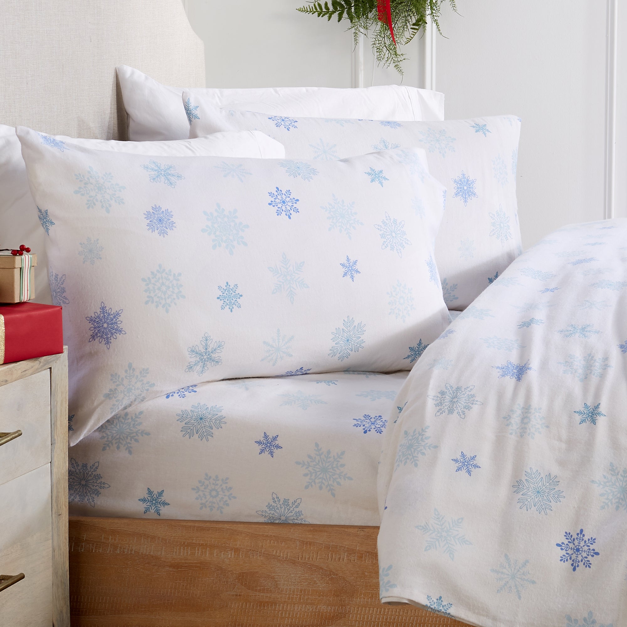 Printed 100% Turkish cotton flannel sheet set featuring assorted winter-inspired patterns, including woodland animals, snowflakes, trees, plaids, and seasonal motifs. Soft, cozy bedding shown in styled bedroom settings with close-up fabric details and folded sheet stacks in multiple designs.