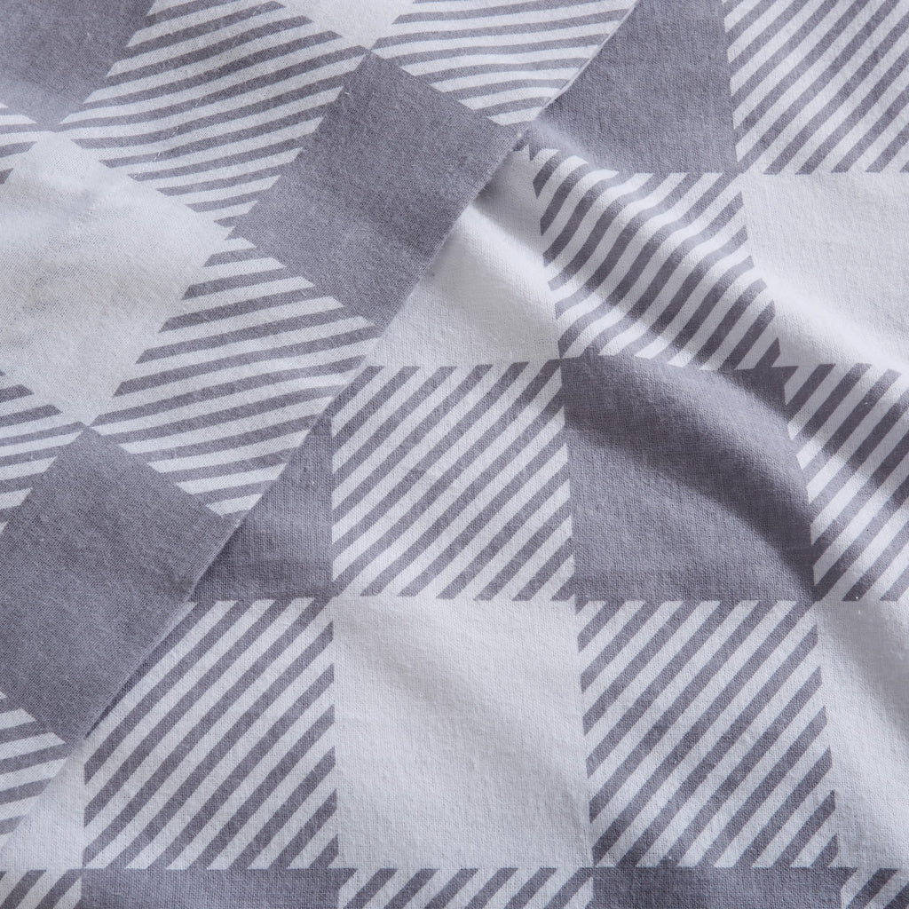 Printed 100% Turkish cotton flannel sheet set featuring assorted winter-inspired patterns, including woodland animals, snowflakes, trees, plaids, and seasonal motifs. Soft, cozy bedding shown in styled bedroom settings with close-up fabric details and folded sheet stacks in multiple designs.
