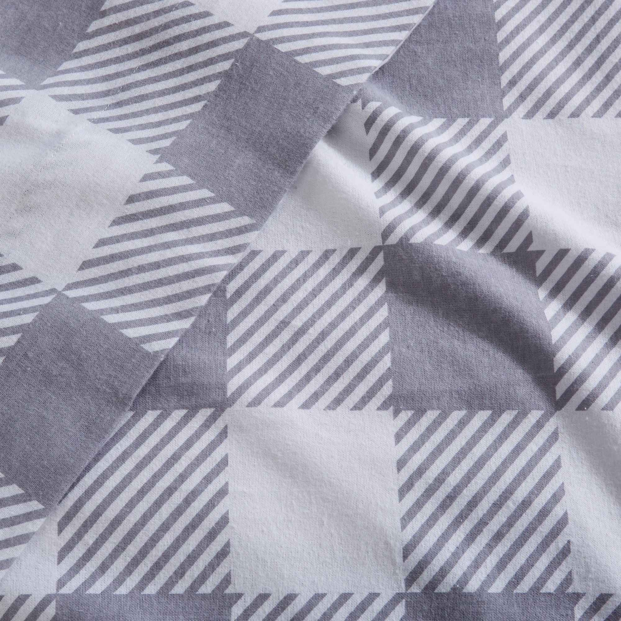 Printed 100% Turkish cotton flannel sheet set featuring assorted winter-inspired patterns, including woodland animals, snowflakes, trees, plaids, and seasonal motifs. Soft, cozy bedding shown in styled bedroom settings with close-up fabric details and folded sheet stacks in multiple designs.