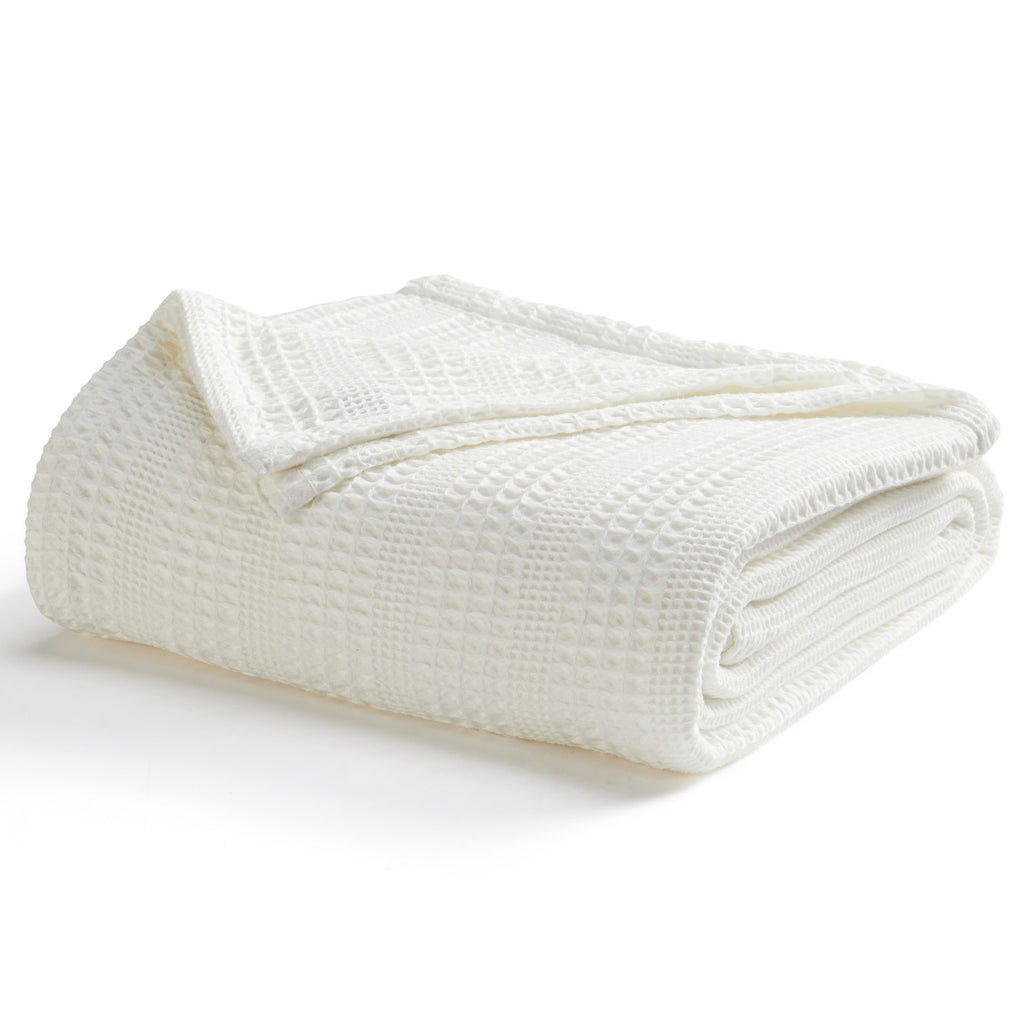 Soft and breathable 100% cotton waffle weave blanket, shown layered on a bed or folded for display. Lightweight and versatile, this textured blanket adds casual comfort and timeless style to any bedroom or living space. Available in Full/Queen and King sizes.