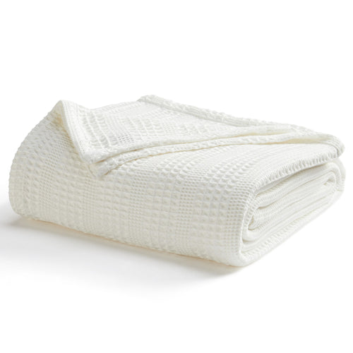 Soft and breathable 100% cotton waffle weave blanket, shown layered on a bed or folded for display. Lightweight and versatile, this textured blanket adds casual comfort and timeless style to any bedroom or living space. Available in Full/Queen and King sizes.