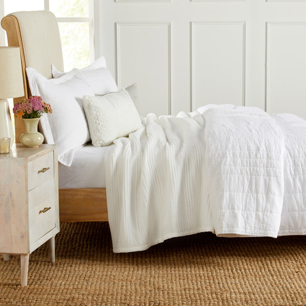 Soft and breathable 100% cotton waffle weave blanket, shown layered on a bed or folded for display. Lightweight and versatile, this textured blanket adds casual comfort and timeless style to any bedroom or living space. Available in Full/Queen and King sizes.