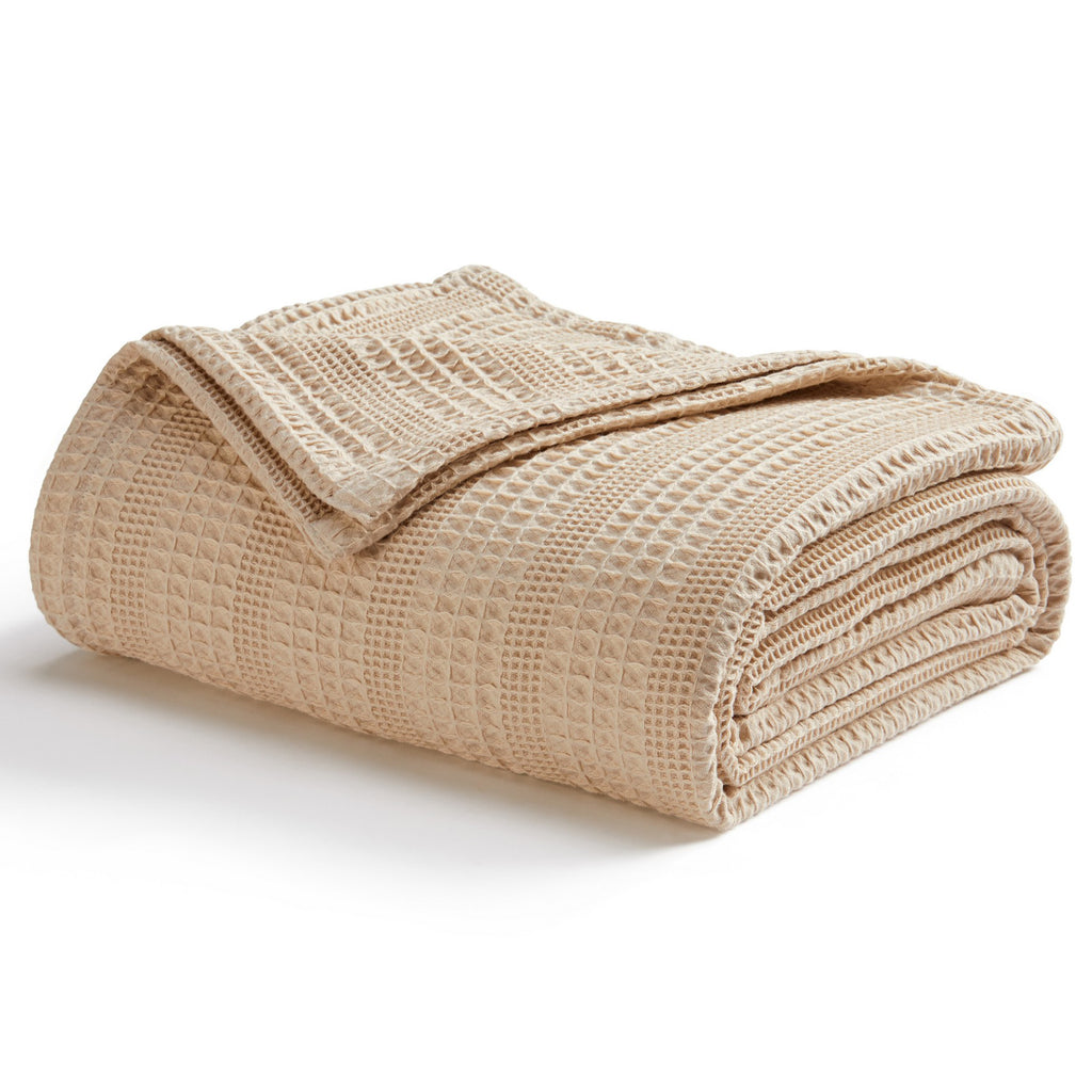 Soft and breathable 100% cotton waffle weave blanket, shown layered on a bed or folded for display. Lightweight and versatile, this textured blanket adds casual comfort and timeless style to any bedroom or living space. Available in Full/Queen and King sizes.