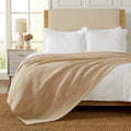 Soft and breathable 100% cotton waffle weave blanket, shown layered on a bed or folded for display. Lightweight and versatile, this textured blanket adds casual comfort and timeless style to any bedroom or living space. Available in Full/Queen and King sizes.