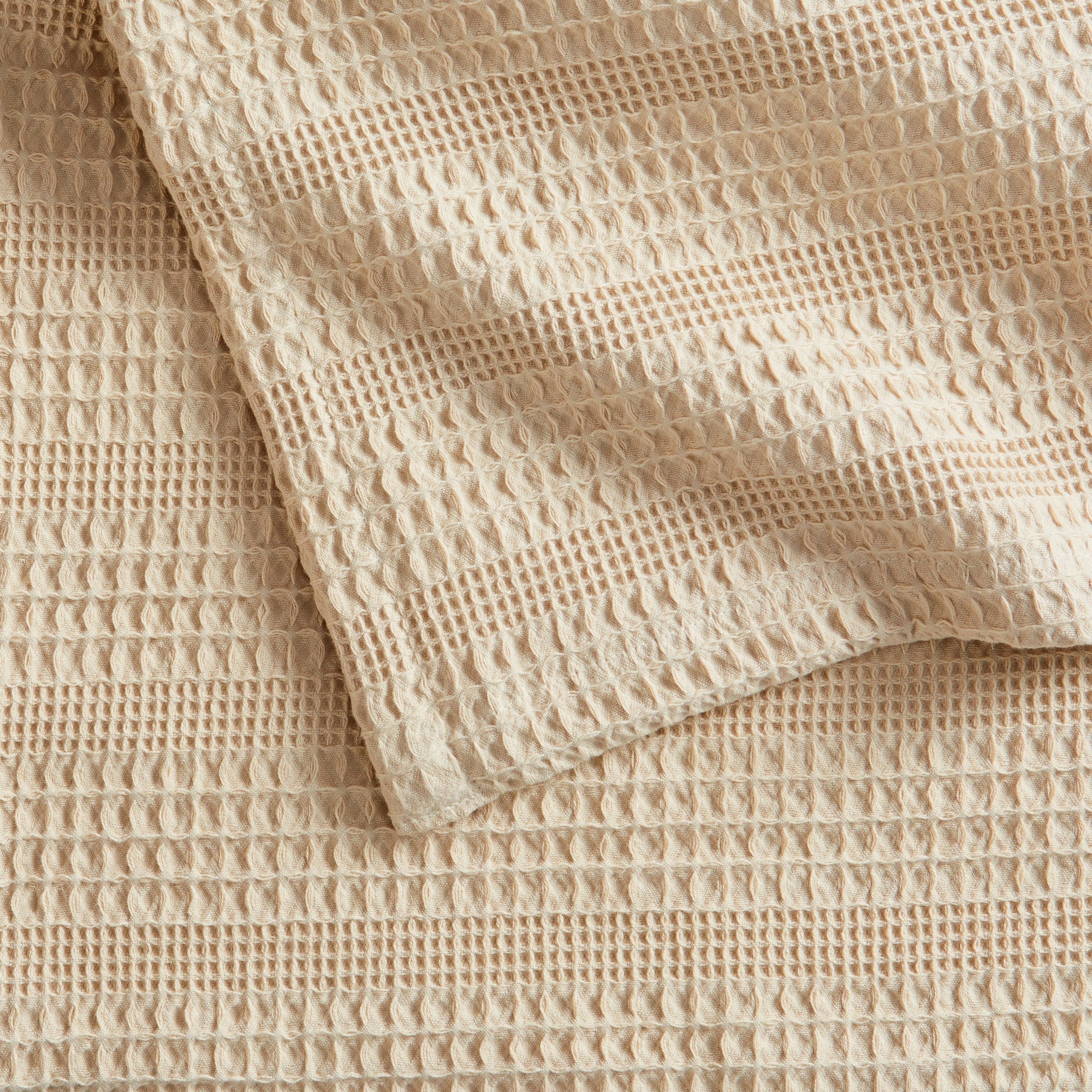 Soft and breathable 100% cotton waffle weave blanket, shown layered on a bed or folded for display. Lightweight and versatile, this textured blanket adds casual comfort and timeless style to any bedroom or living space. Available in Full/Queen and King sizes.