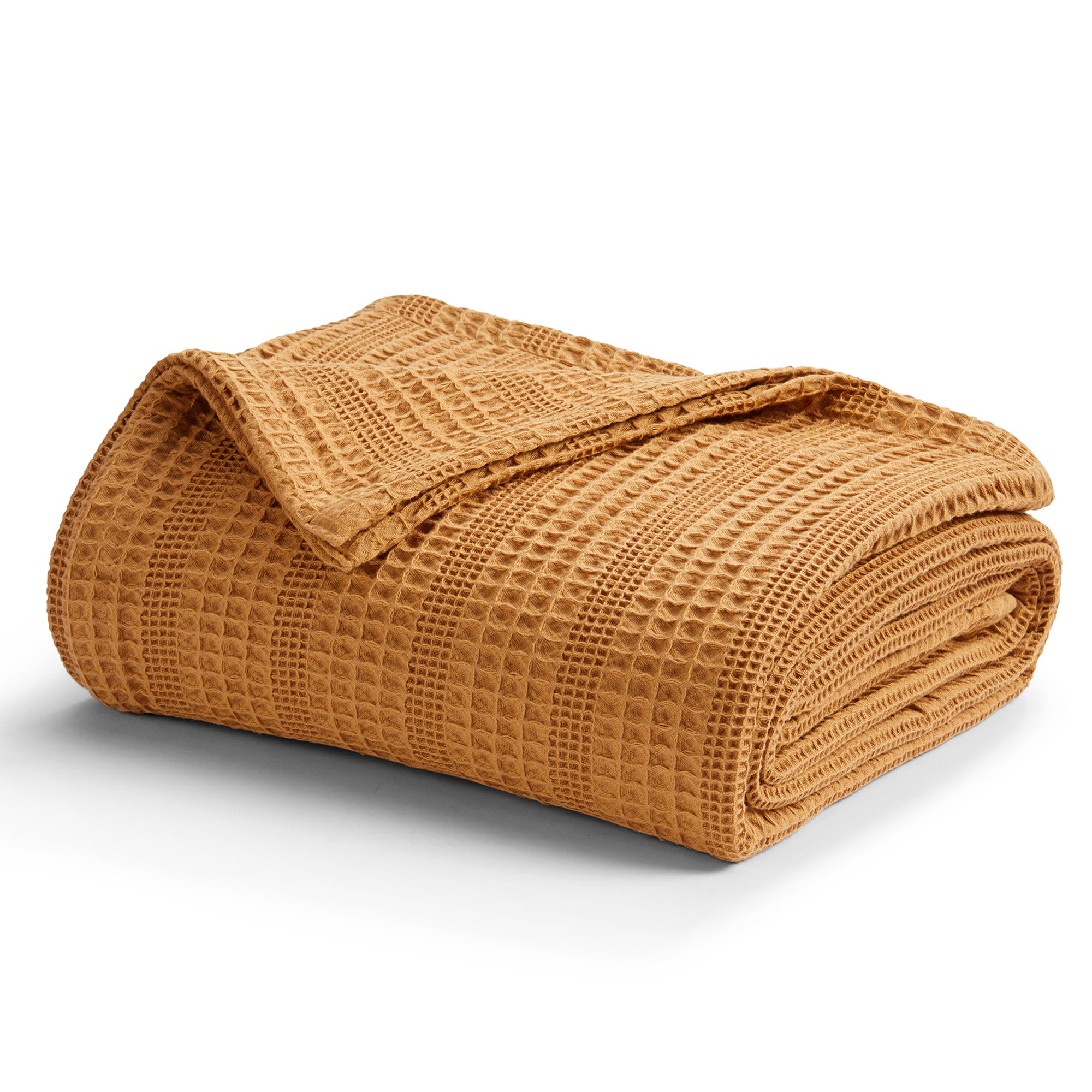 Soft and breathable 100% cotton waffle weave blanket, shown layered on a bed or folded for display. Lightweight and versatile, this textured blanket adds casual comfort and timeless style to any bedroom or living space. Available in Full/Queen and King sizes.
