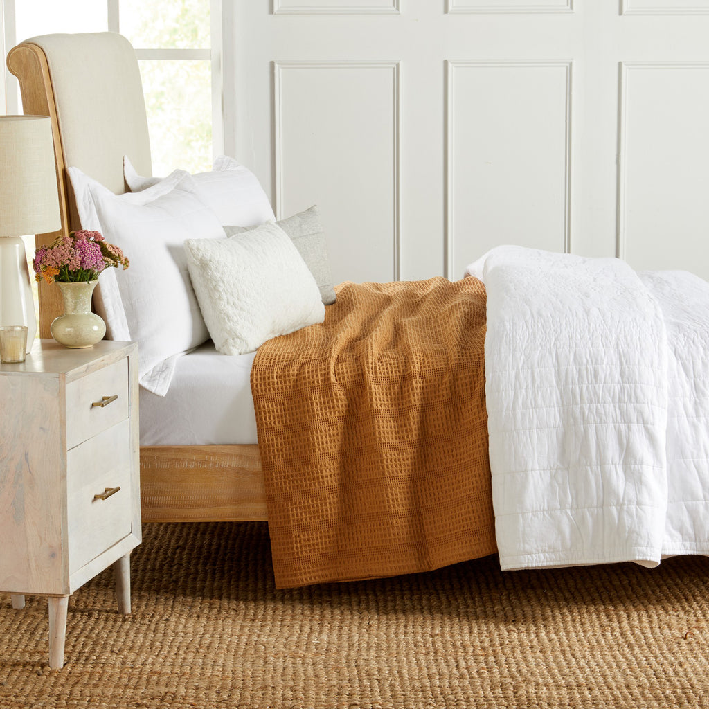 Soft and breathable 100% cotton waffle weave blanket, shown layered on a bed or folded for display. Lightweight and versatile, this textured blanket adds casual comfort and timeless style to any bedroom or living space. Available in Full/Queen and King sizes.