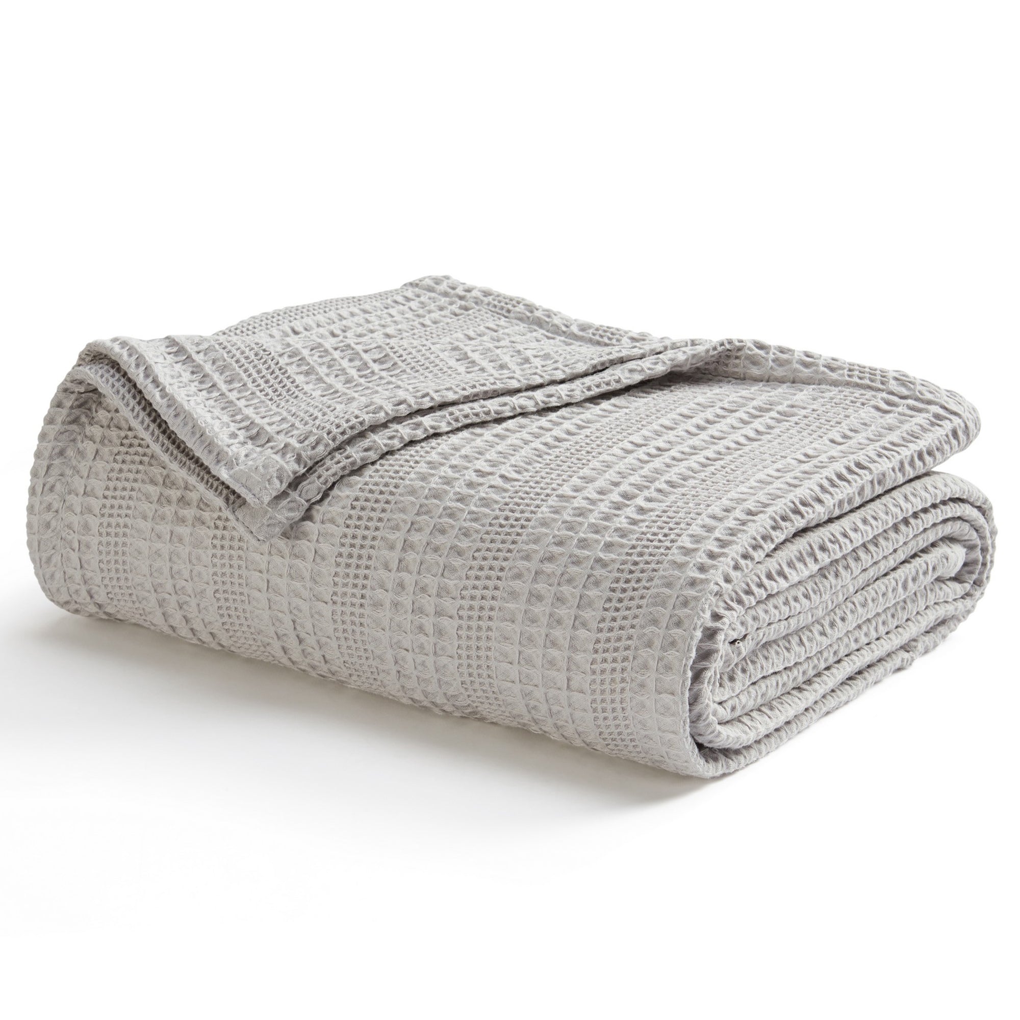 Soft and breathable 100% cotton waffle weave blanket, shown layered on a bed or folded for display. Lightweight and versatile, this textured blanket adds casual comfort and timeless style to any bedroom or living space. Available in Full/Queen and King sizes.