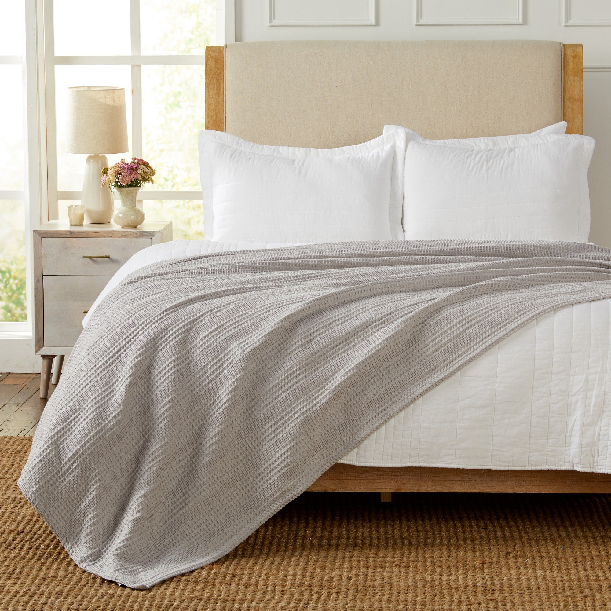 Soft and breathable 100% cotton waffle weave blanket, shown layered on a bed or folded for display. Lightweight and versatile, this textured blanket adds casual comfort and timeless style to any bedroom or living space. Available in Full/Queen and King sizes.