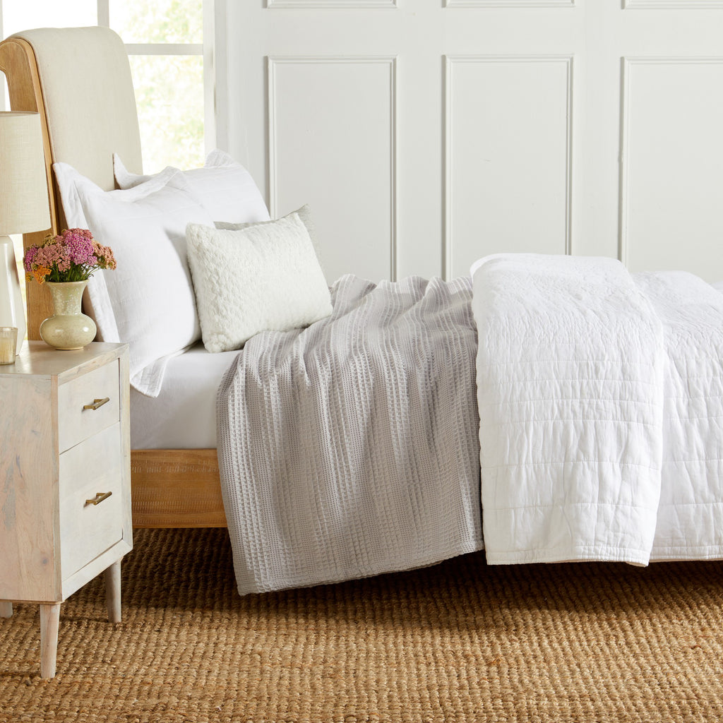 Soft and breathable 100% cotton waffle weave blanket, shown layered on a bed or folded for display. Lightweight and versatile, this textured blanket adds casual comfort and timeless style to any bedroom or living space. Available in Full/Queen and King sizes.
