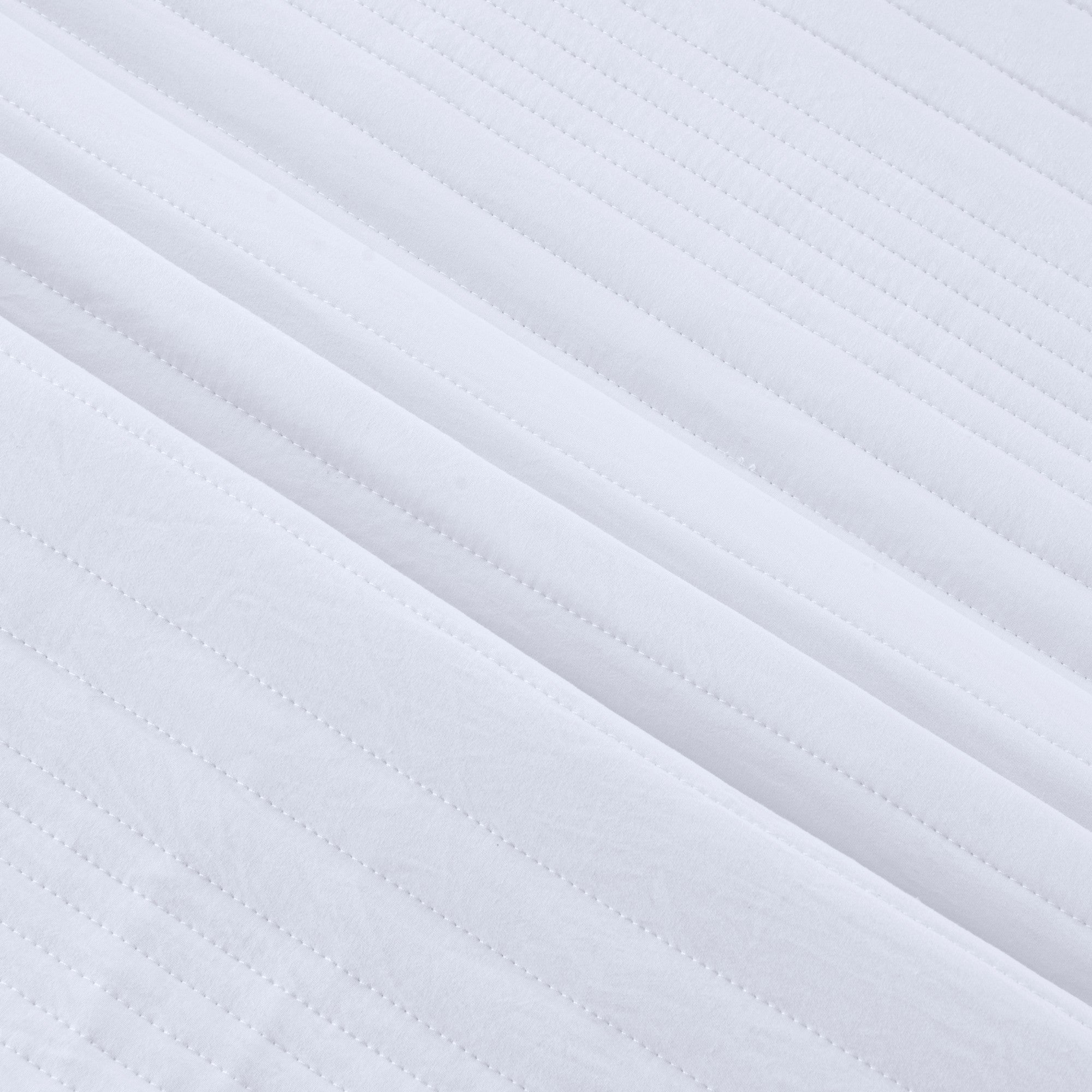 Parker Collection Solid Embroidered Quilt Set by Market & Place featuring soft microfiber construction and elegant channel embroidery. Available in multiple colors with coordinating shams and detailed fabric close-ups, styled in a modern bedroom setting.