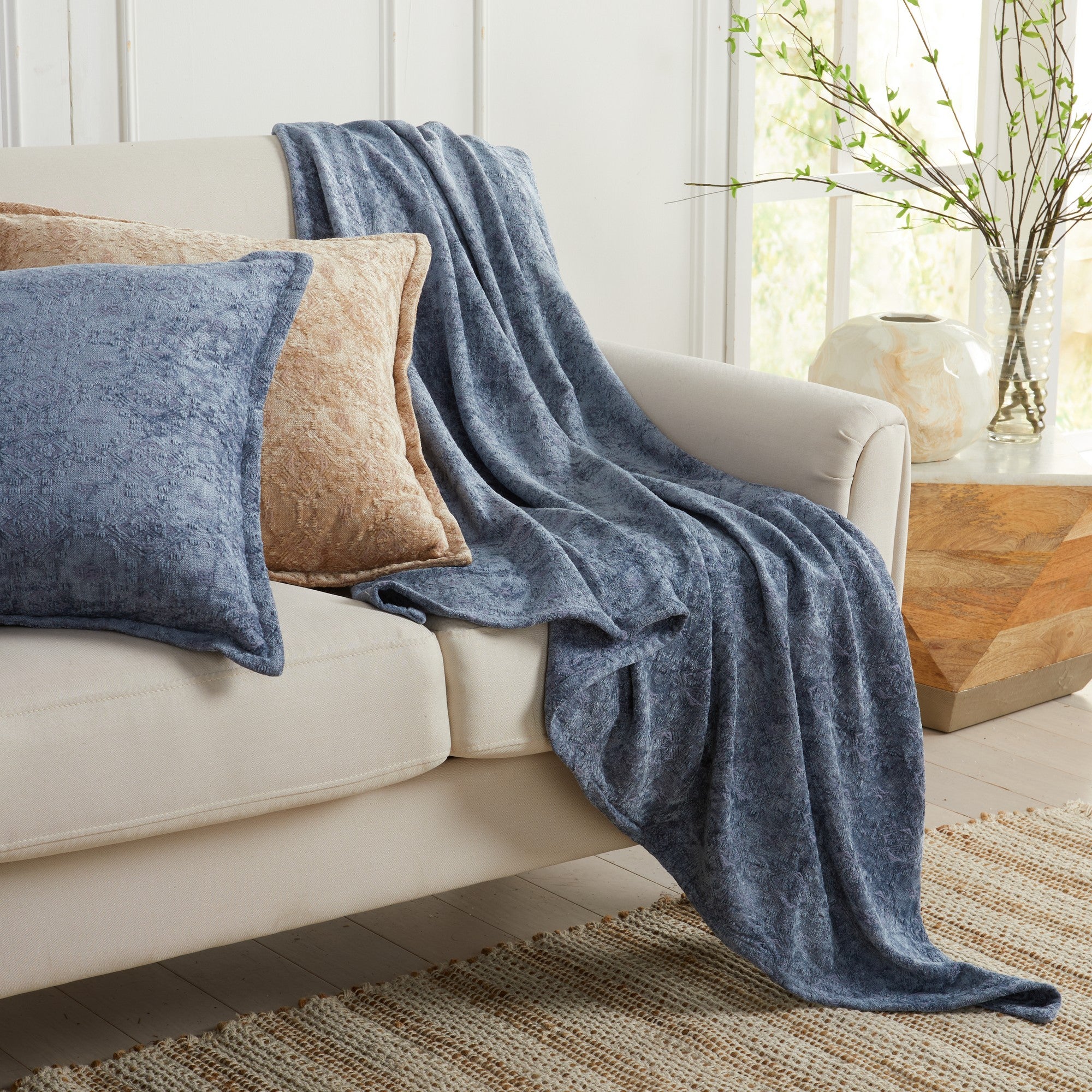 Blue Charlotte Collection Chenille Jacquard Throw Blanket draped over a sofa with coordinating accent pillows, featuring soft chenille fabric, textured jacquard detailing, and a lightweight decorative design.