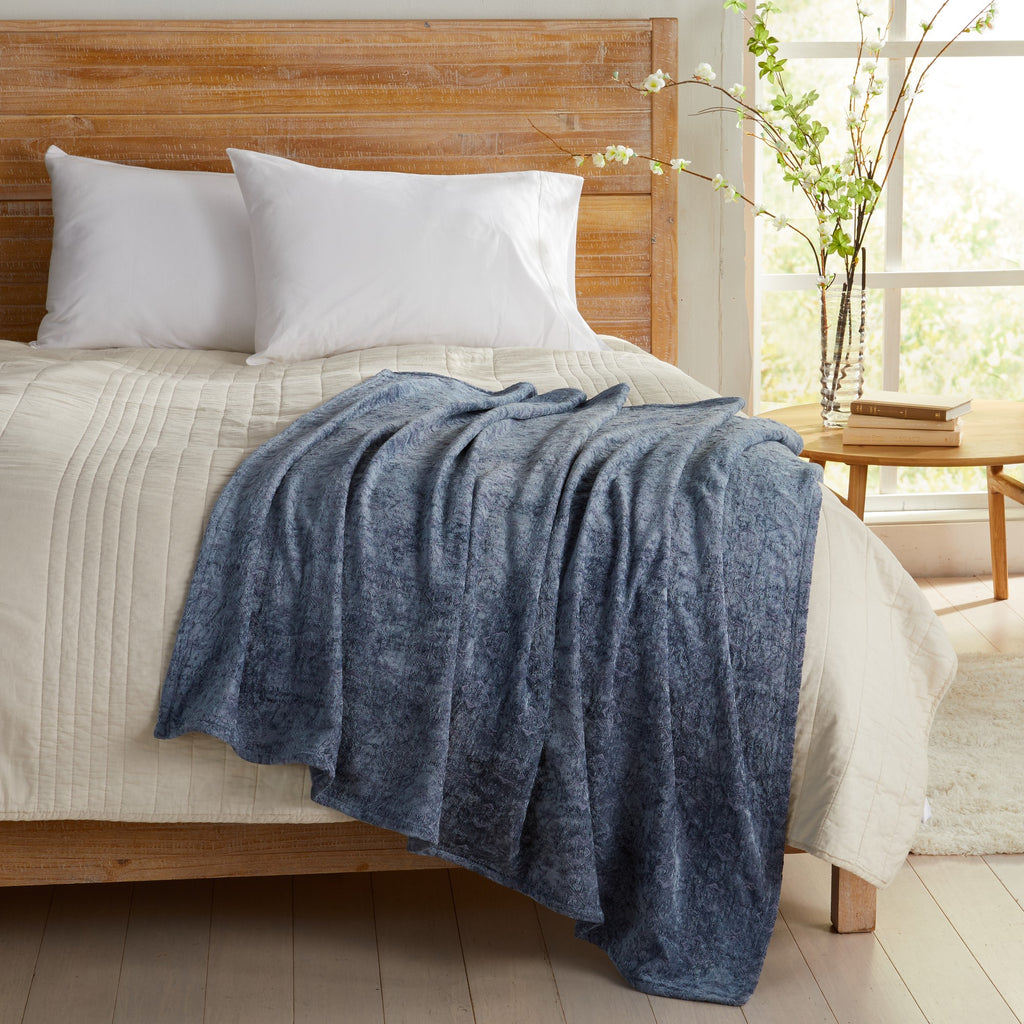 Blue Charlotte Collection Chenille Jacquard Throw Blanket draped across bed, soft textured chenille fabric adding warmth and comfort to farmhouse, coastal, and modern bedroom décor.