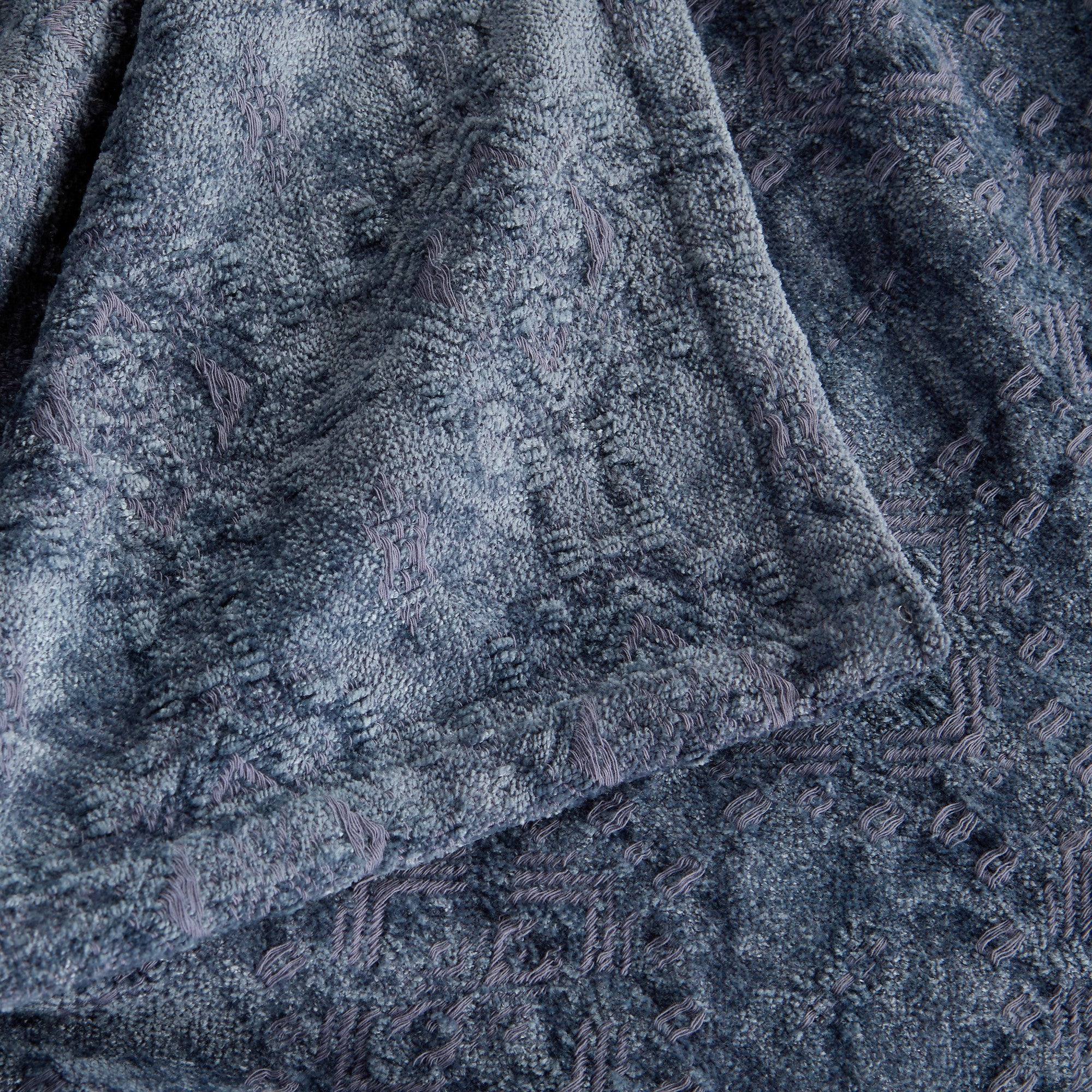 Close-up of the Blue Charlotte Collection Chenille Jacquard Throw Blanket showcasing its soft chenille texture, woven jacquard pattern, and decorative edge detailing.