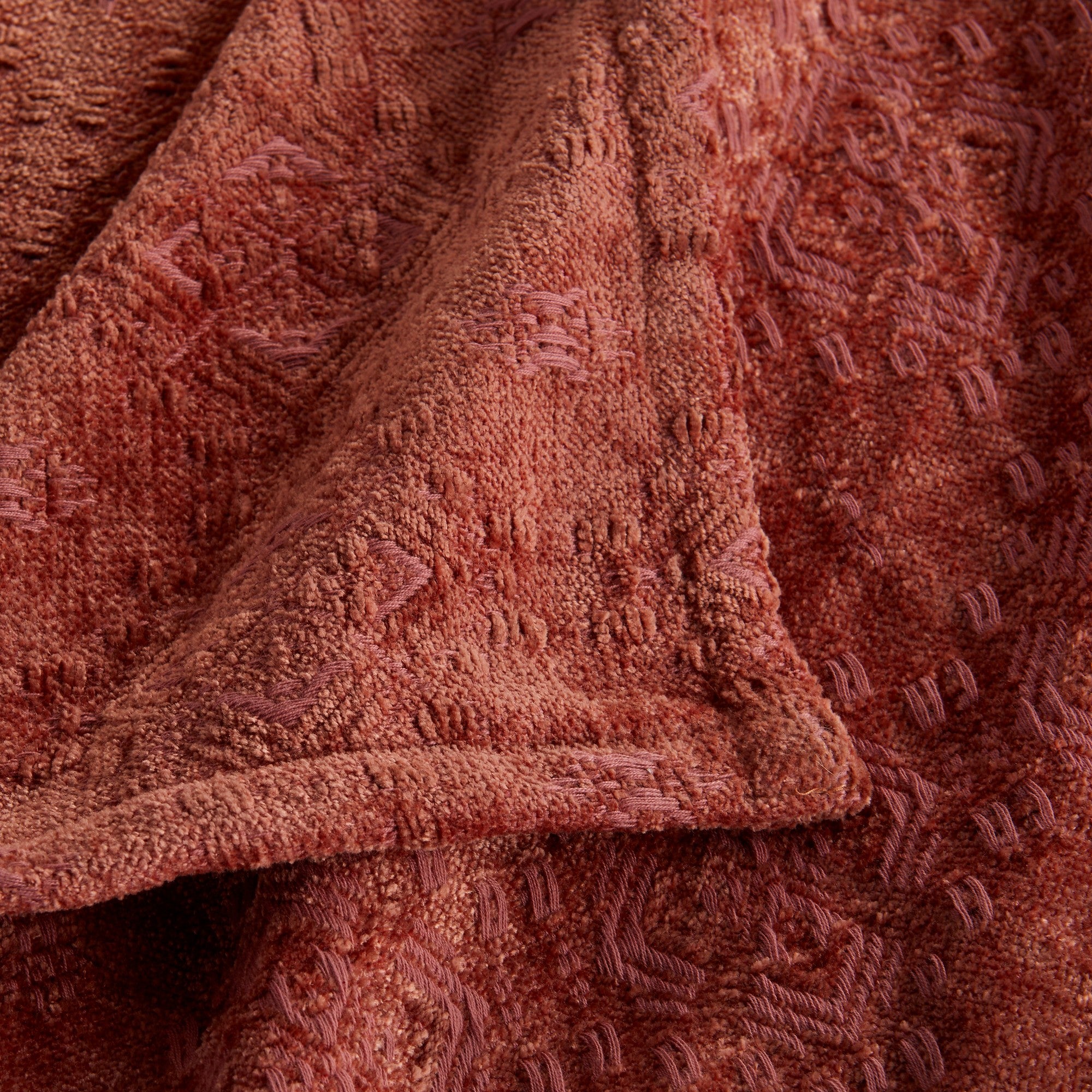 Close-up of the Rose Charlotte Collection Chenille Jacquard Throw Blanket featuring a soft chenille texture, intricate woven jacquard pattern, and decorative finished edge.