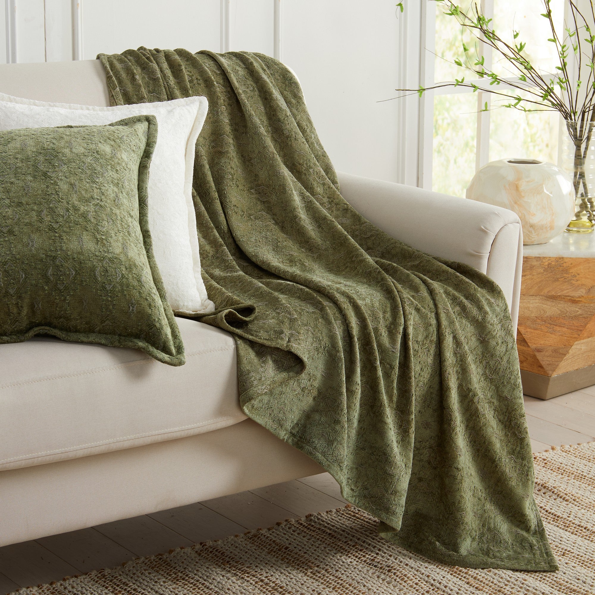 Sage Charlotte Collection Chenille Jacquard Throw Blanket draped over sofa with matching decorative pillow, soft textured chenille fabric for cozy farmhouse and contemporary home décor.
