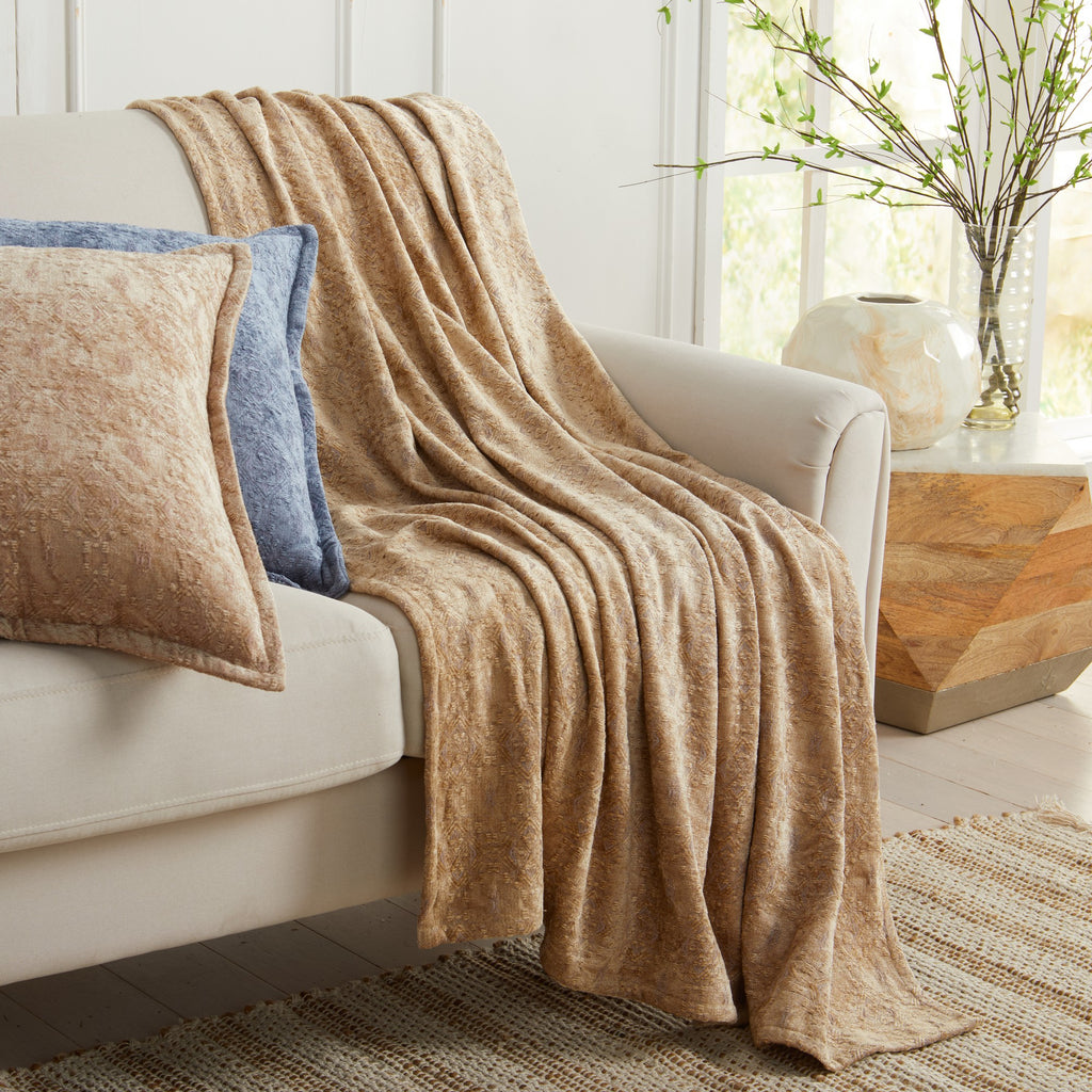 Beige Charlotte Collection Chenille Jacquard Throw Blanket draped over sofa with coordinating decorative pillows, soft textured chenille fabric for cozy farmhouse and contemporary home décor.
