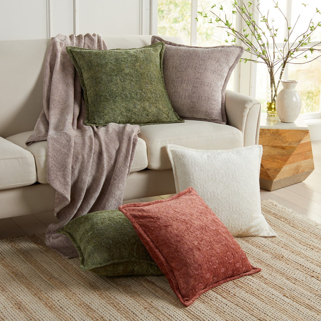 A set of chenille jacquard pillow covers in various solid colors including beige, blue, gray, rose, sage, and white, displayed on a sofa with a decorative throw blanket.