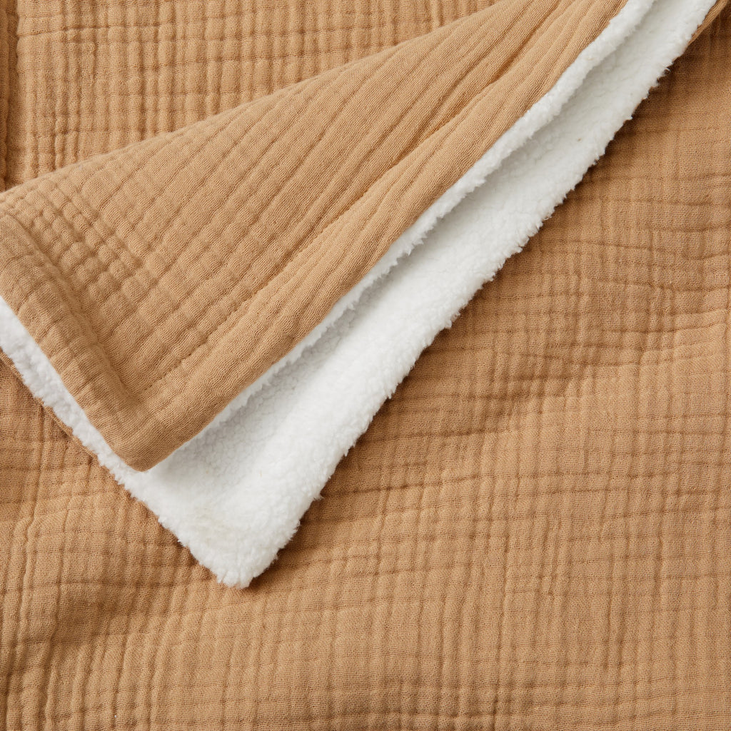Close-up of the Beige Maria Collection cotton muslin sherpa throw blanket, showcasing the soft quilted cotton muslin texture and plush sherpa reverse for added warmth and comfort.