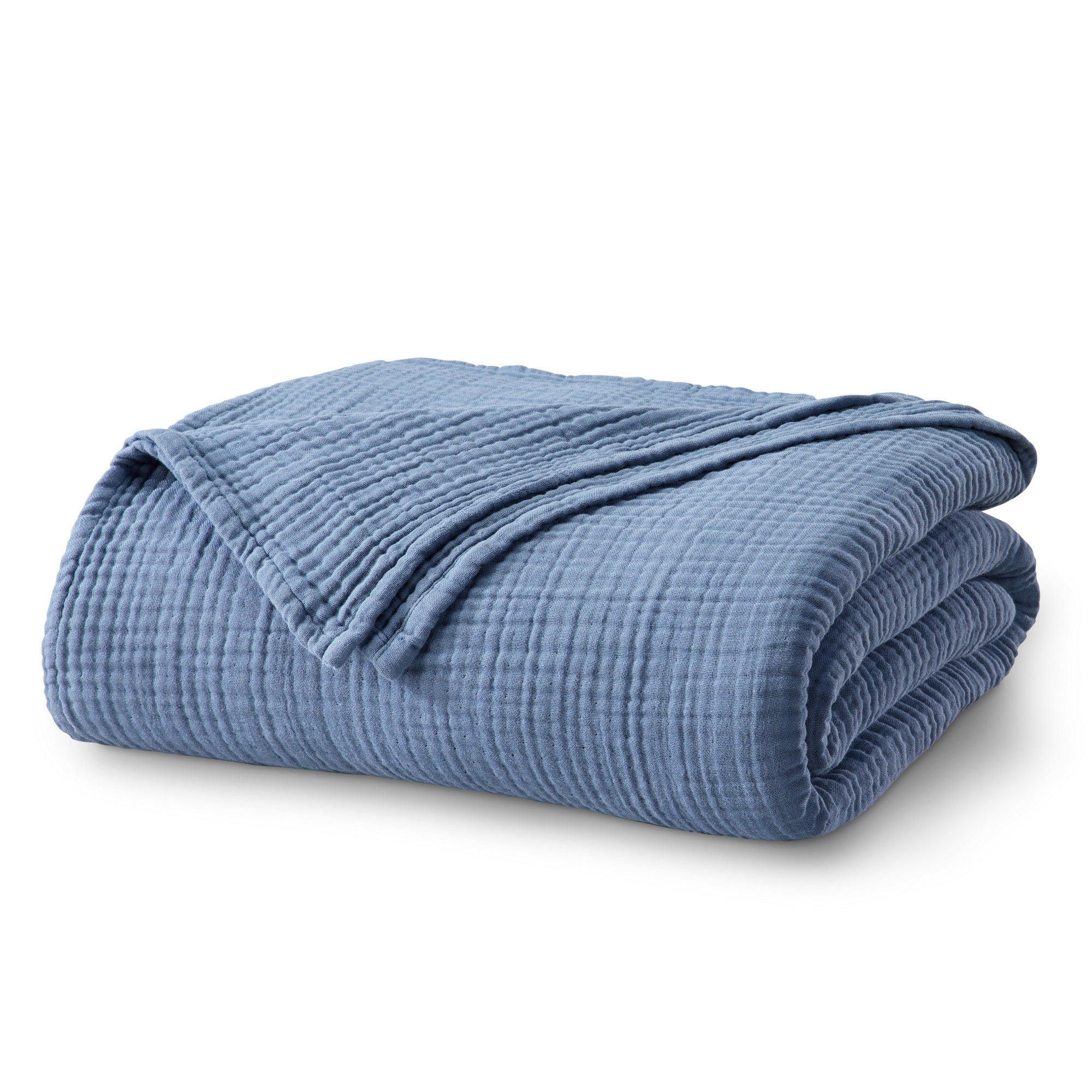 Folded Blue Maria Collection cotton muslin blanket featuring a soft textured muslin weave and calming blue color, neatly displayed to highlight its breathable comfort, lightweight construction, and relaxed contemporary style.