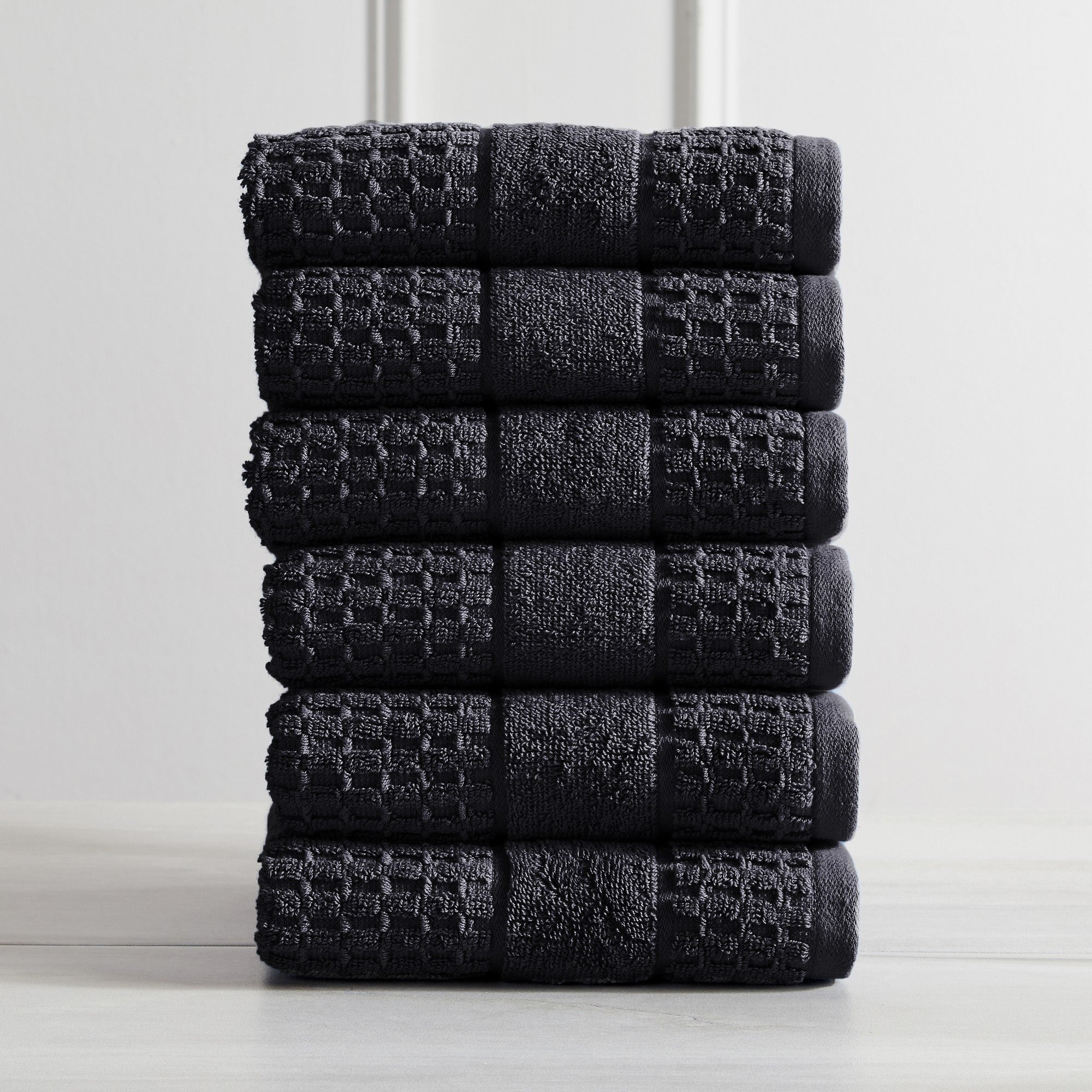 Harper Collection Waffle Textured Bath Towels by Market & Place featuring premium 100% cotton construction with a stylish waffle weave texture. Available in multiple colors and set configurations, including bath towels, hand towels, and washcloths, shown folded, stacked, and styled to highlight their soft, plush, and highly absorbent design.