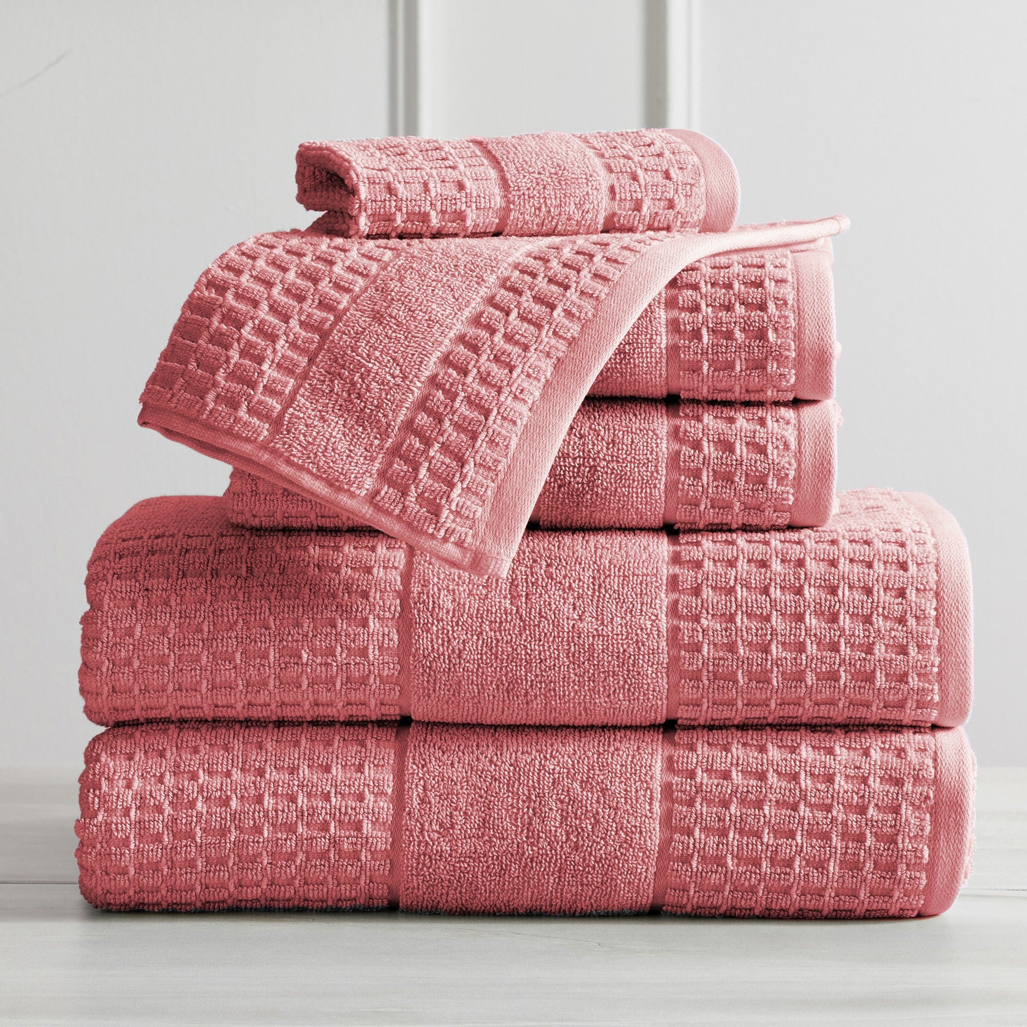 Harper Collection Waffle Textured Bath Towels by Market & Place featuring premium 100% cotton construction with a stylish waffle weave texture. Available in multiple colors and set configurations, including bath towels, hand towels, and washcloths, shown folded, stacked, and styled to highlight their soft, plush, and highly absorbent design.