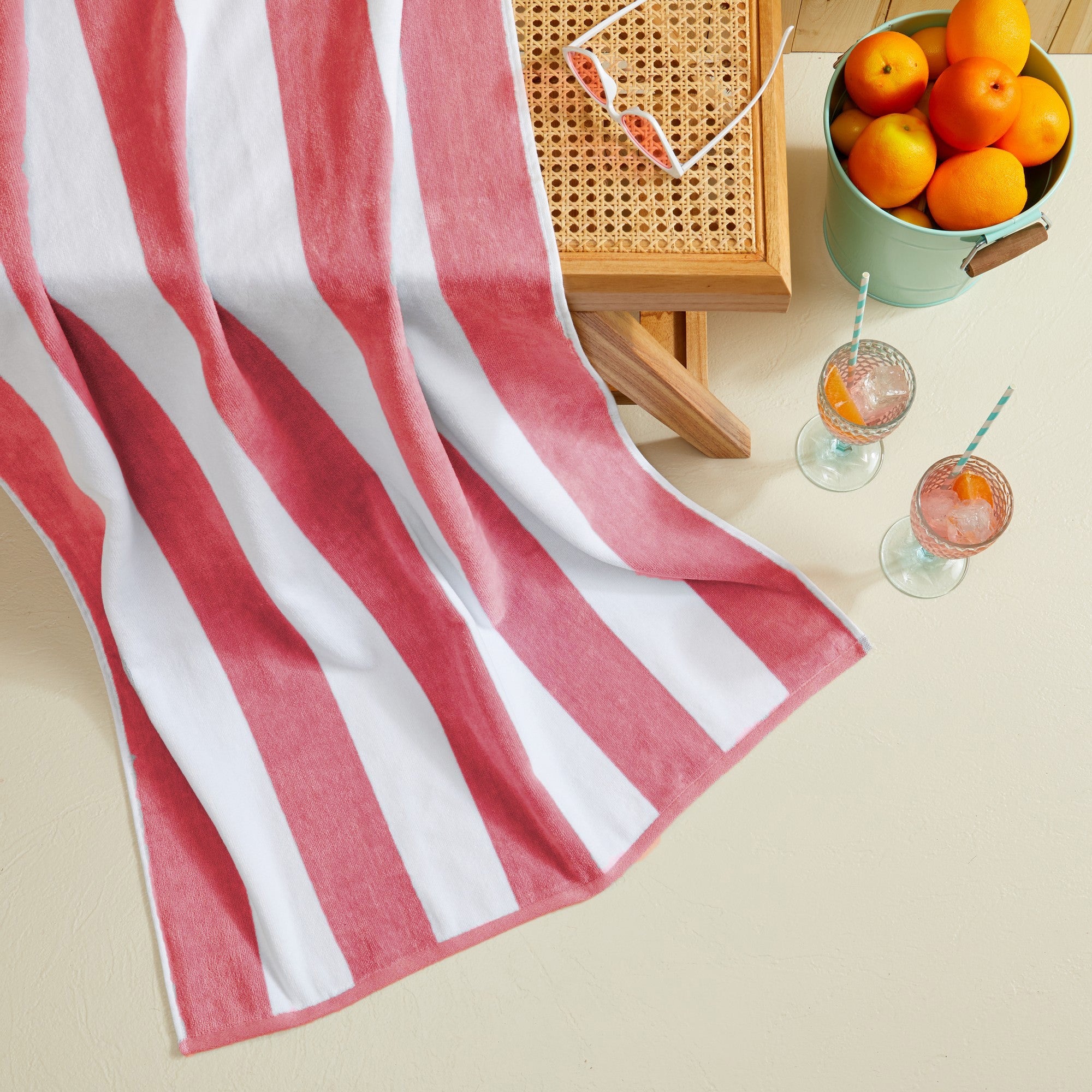 Marina Collection cotton cabana stripe beach towels in assorted colors and sizes, featuring classic striped designs and soft, absorbent 100% cotton velour construction, shown folded, stacked, and styled for poolside and beach use.