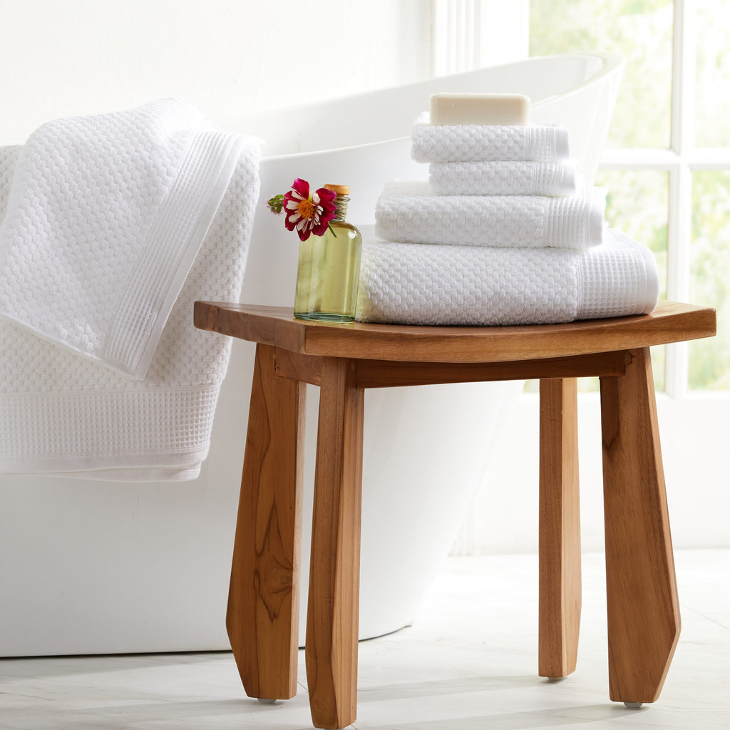 White waffle weave cotton bath towels displayed in modern bathroom