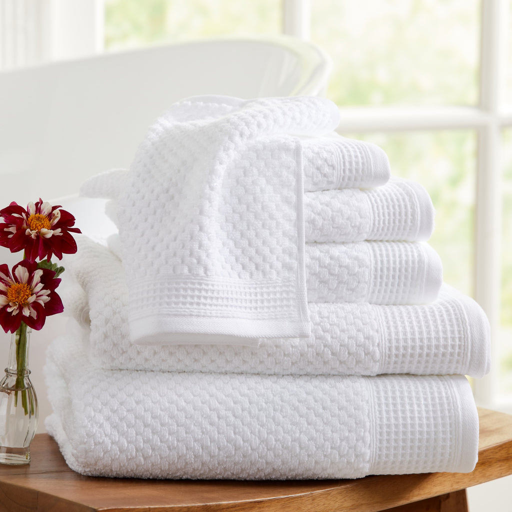 Close-up of white cotton bath towels with textured weave