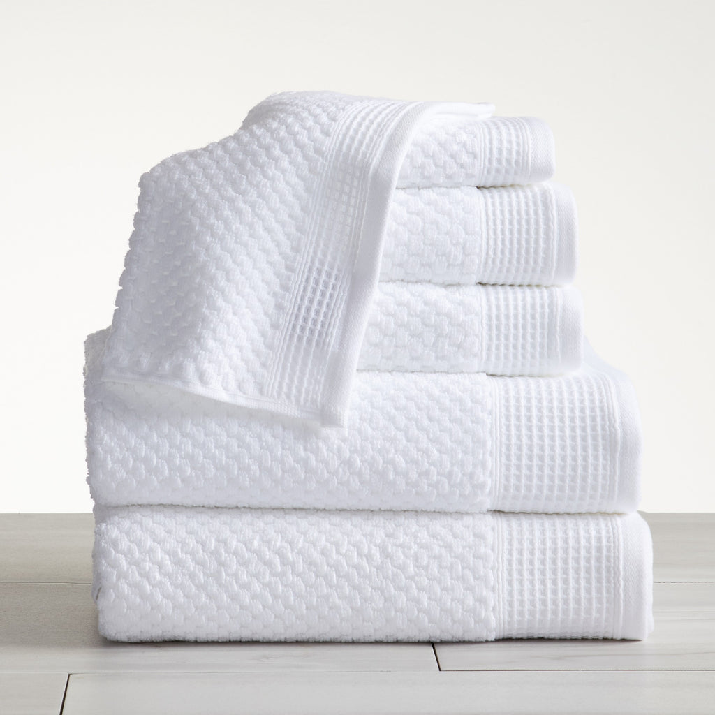 Close-up of white cotton bath towels with textured weave