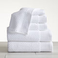 Close-up of white cotton bath towels with textured weave